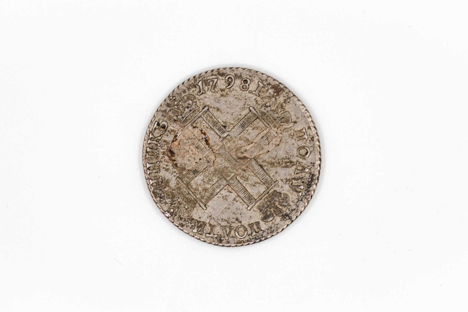 A silver coin of the Austrian Netherlands, dated 1798: A silver coin of the Austrian Netherlands, dated 1798. Obverse with crossed implements beneath the date. Reverse with ornamental cartouche enclosing multi-line inscription. Weight: 5,1g