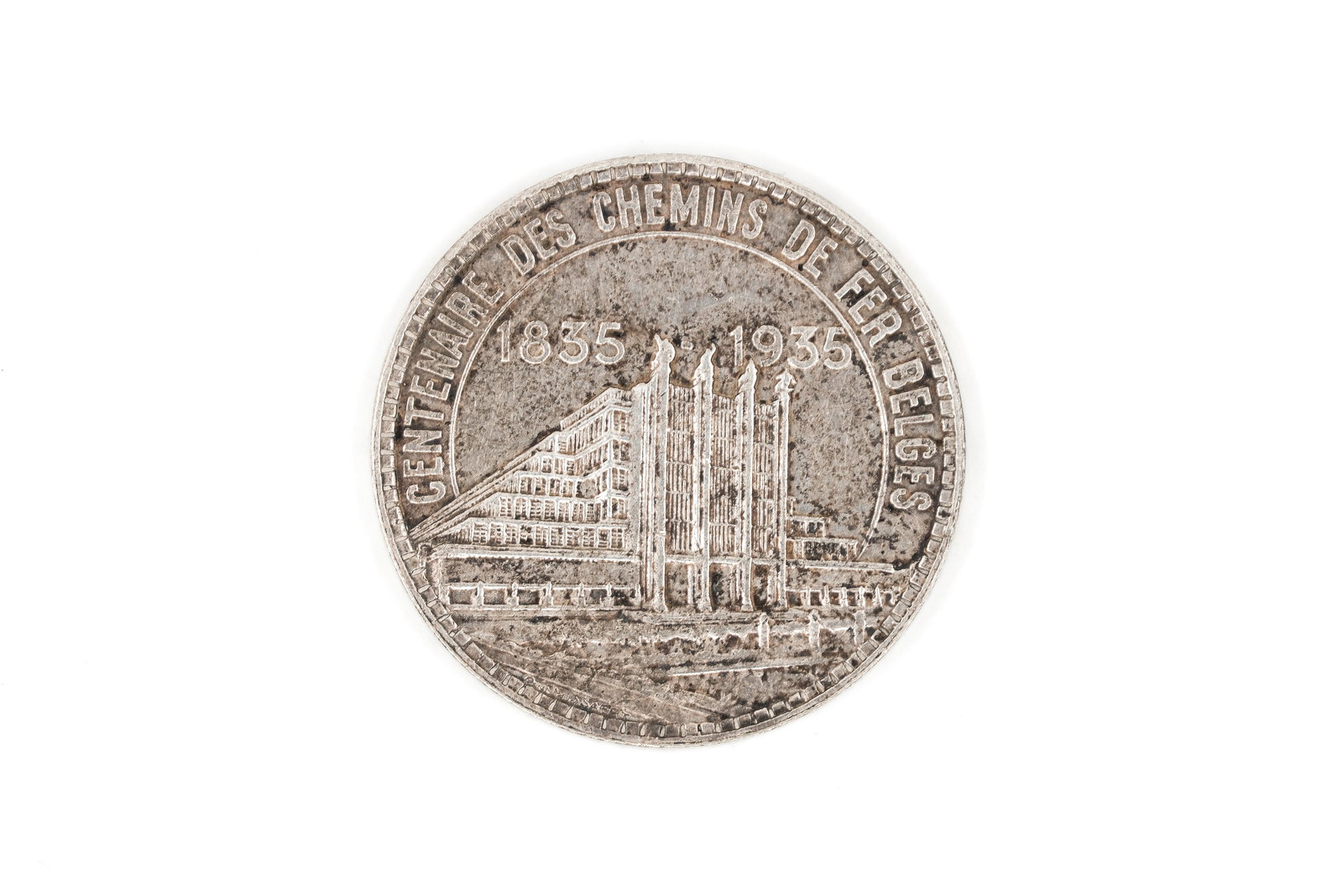 A Belgian silver 50 Francs commemorative coin: A Belgian silver 50 Francs commemorative coin. Obverse with standing armored figure and inscription referring to the Exposition of Belgium, denomination 50 FR. Reverse with architectural view and insc