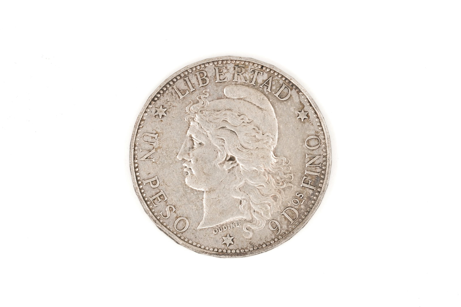 An Argentine silver 1 Peso coin, dated 1882: An Argentine silver 1 Peso coin, dated 1882. With Liberty head obverse and national arms within wreath reverse. Weight: 25g