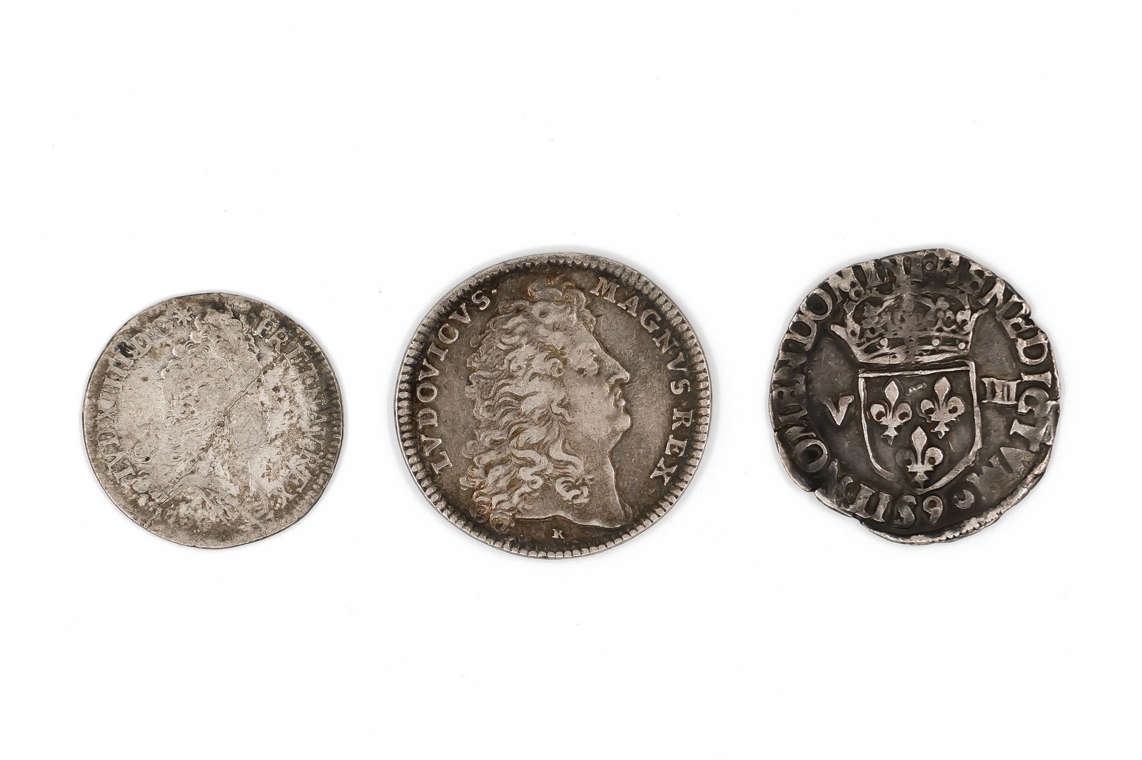 A lot of three European silver coins, dated 17th-18th century: A lot of three European silver coins, dated 17th-18th century. Featuring royal portrait obverses and heraldic shield and cross reverses. Weight: 2,8 - 9 - 4,7g