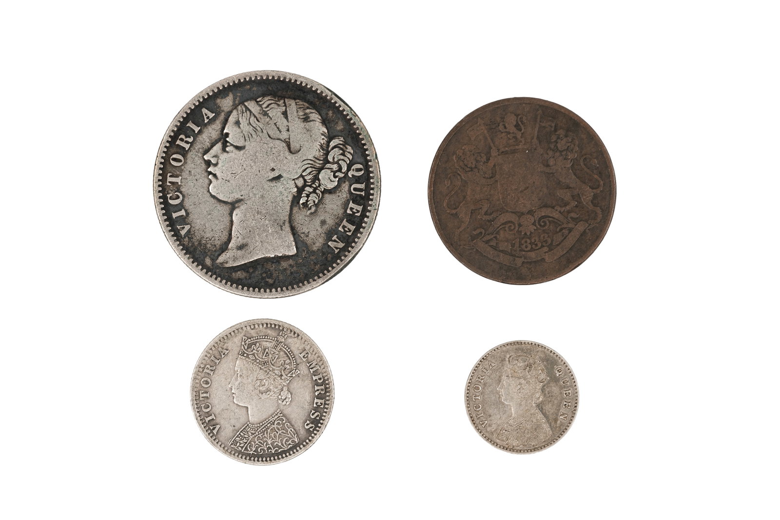 A lot of four British and colonial coins, dated 1833-1886: A lot of four British and colonial coins, dated 1833-1886. Comprising issues of Queen Victoria and British India, including a One Rupee dated 1840, a Quarter Rupee dated 1886, and smaller denomination