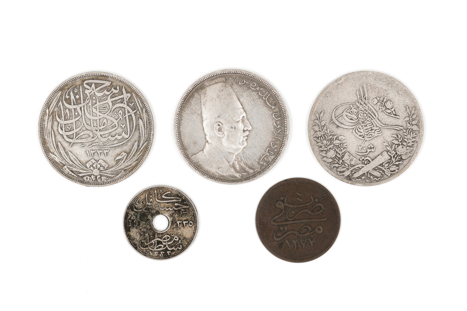 A lot of five Middle Eastern and North African coins: A lot of five Middle Eastern and North African coins. Comprising various Ottoman and Egyptian issues, including a 20 Piastres piece dated 1917, smaller denomination coins with tughra and Arabic inscri