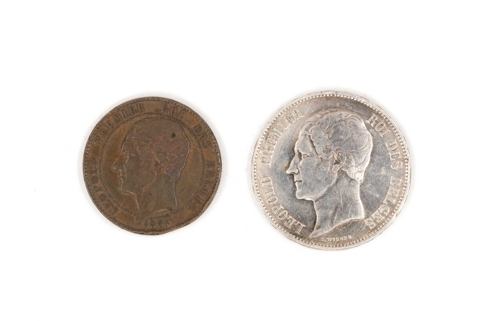 A lot of two Belgian coins of Leopold I, dated 1853: A lot of two Belgian coins of Leopold I, dated 1853. Comprising one copper issue with bare head portrait and one silver 5 Francs commemorative coin depicting conjoined busts of Leopold I and Queen Lou