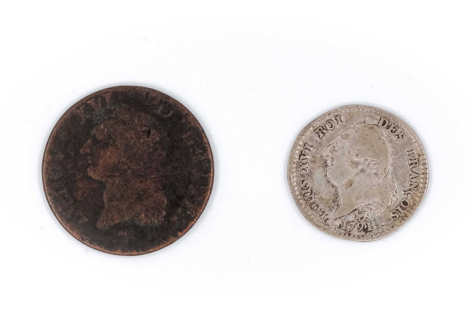 A lot of two French coins, comprising a copper issue and a silver 15 Sols coin: A lot of two French coins, comprising a copper issue and a silver 15 Sols coin, one dated 1791. Including a Louis XVI silver 15 Sols coin with draped bust and reverse featuring the standing Genius ins
