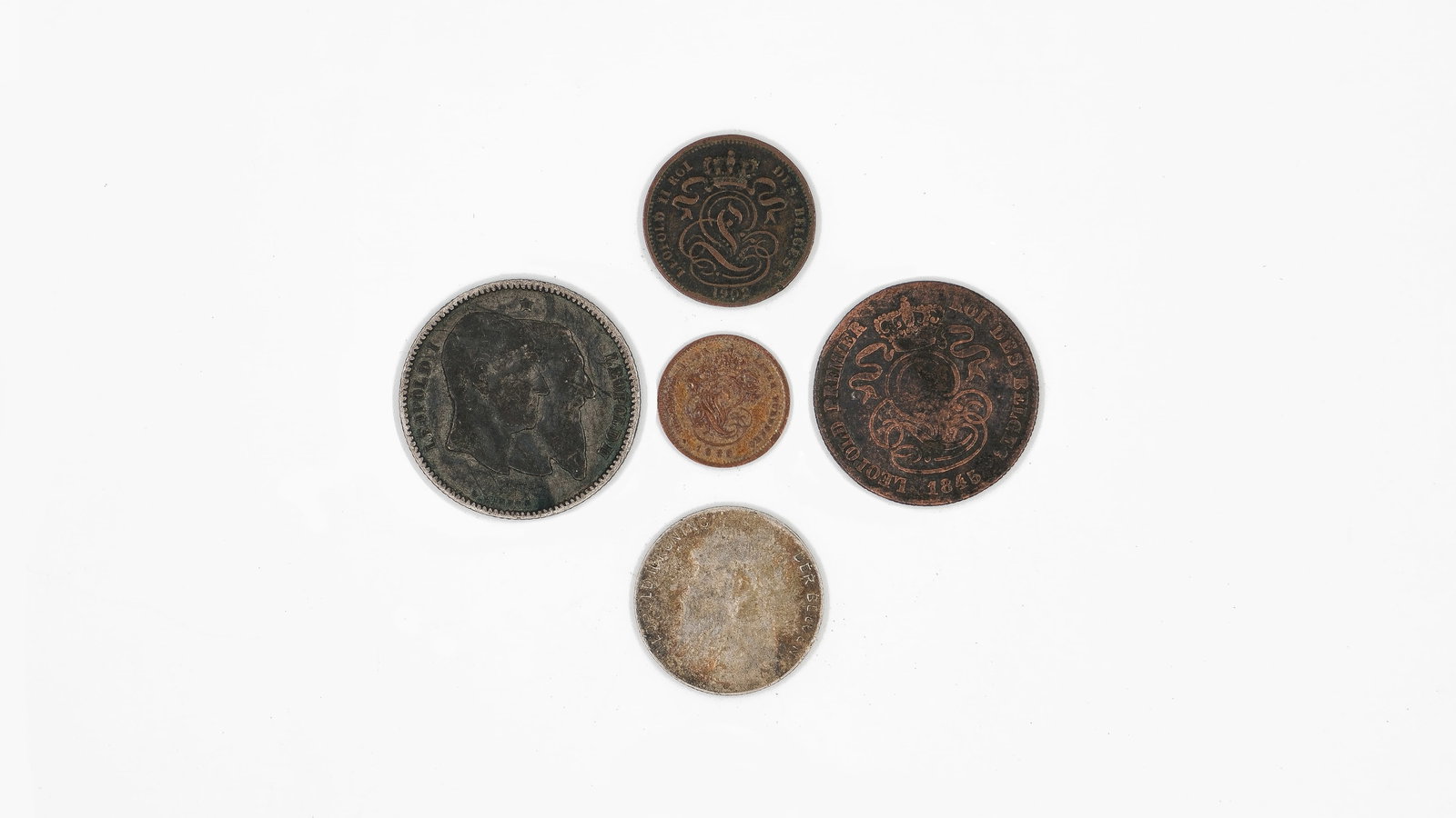 A lot of five Belgian coins from the reigns of Leopold I and Leopold II, dated 1845-1870: A lot of five Belgian coins from the reigns of Leopold I and Leopold II, dated 1845-1870. Comprising copper 1 and 2 Centimes, a 5 Centimes, a silver 50 Centimes, and a silver 1 Franc, with royal portr