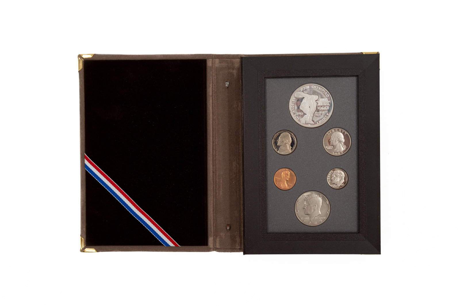 An American six coin 1983 Olympics proof set with silver dollar in box: An American six coin 1983 Olympics proof set with silver dollars in their box/sleeve. 20th century.