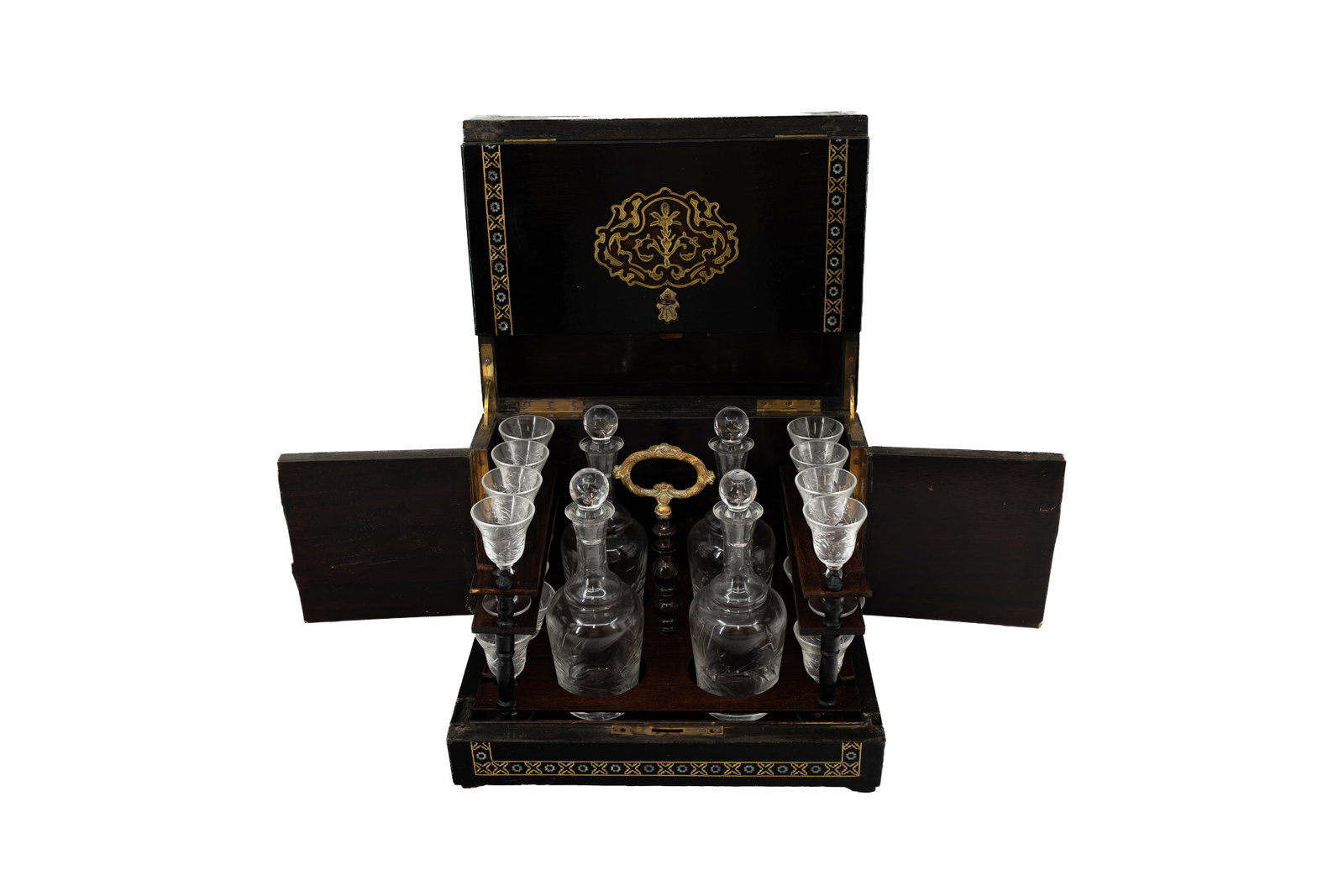 An antique Napoleon III blackened wooden Tantalus liquor cabinet: An antique Napoleon III blackened wooden Tantalus liquor cabinet, finely decorated with marquetry inlay, containing four glass decanters and a set of liquor glasses. 19th century. H: 27 - W: 31 - D: 2