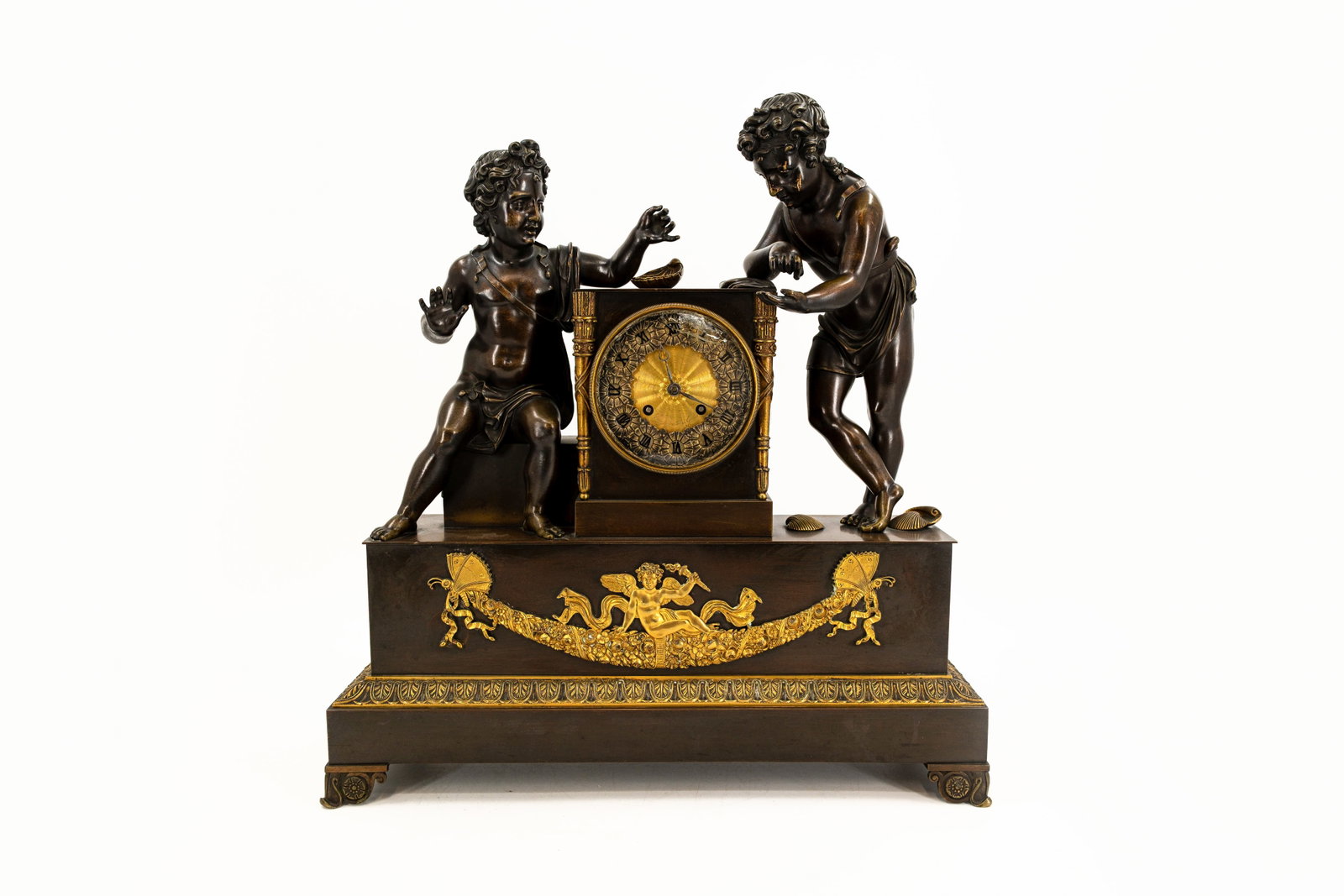A large and antique French gilt and patinated bronze Empire decorated figural mantel clock: A large and antique French gilt and patinated bronze Empire decorated figural mantel clock with two children. Illegible signed, 19th century. H: 50 - W: 47 cm