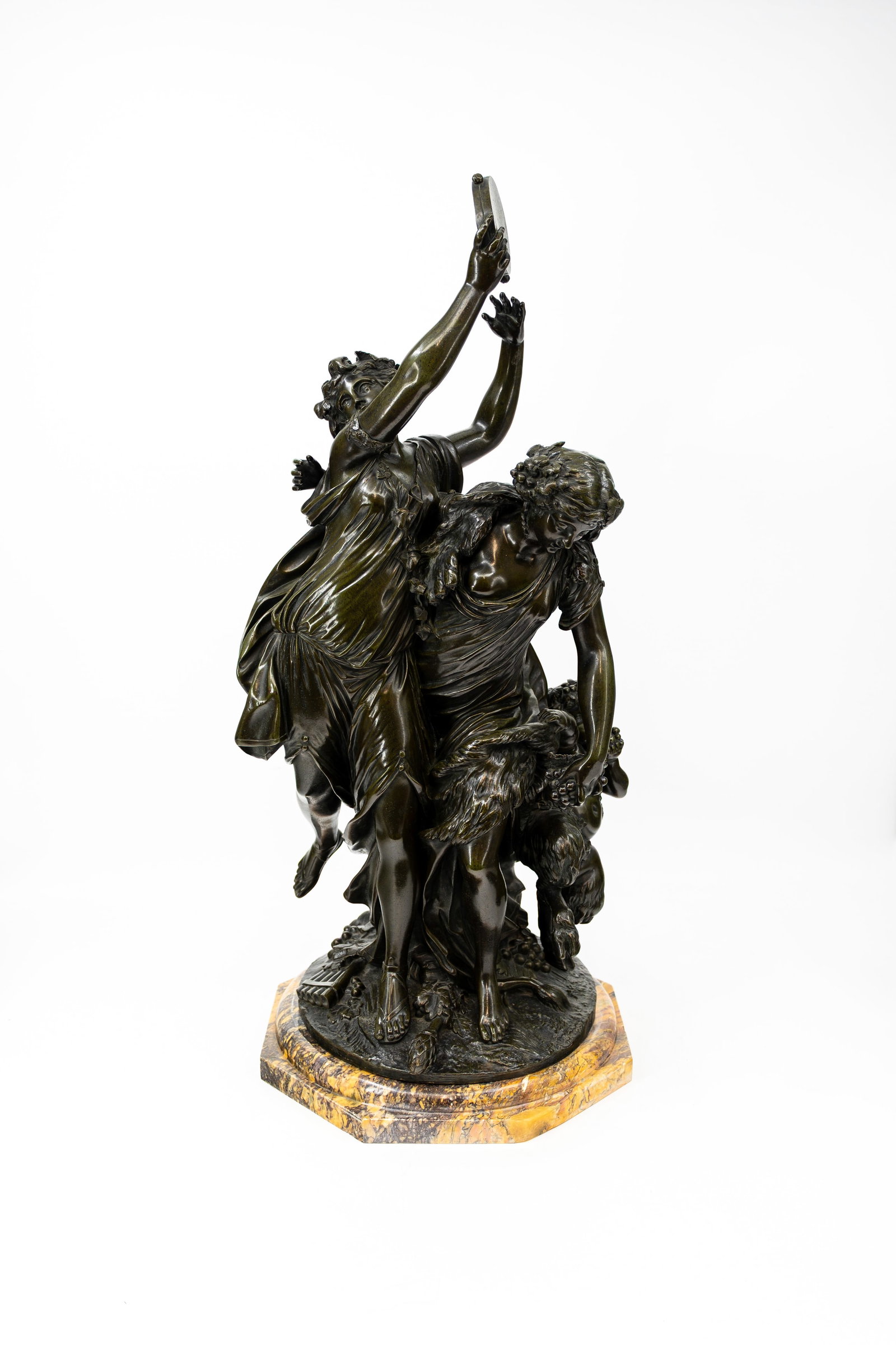 Claude Michel CLODION (1738-1814) After. "Bacchanal". A large and antique patinated bronze sculpture: Claude Michel CLODION (1738-1814) After. "Bacchanal". A large and antique patinated bronze sculpture group depicting two nymphs dancing with the young Bacchus. Footed on marble base. Signed, late 19th