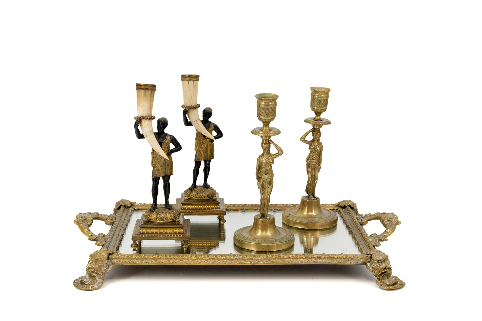 A composed lot of two sets of antique bronze figural candle holders and a large brass serving tray: A composed lot of two sets of antique bronze figural candle holders and two with bone horn, together with a large polished brass serving tray with head shaped foot. Circa 1900. H: 22,5 - 24 cm, candle
