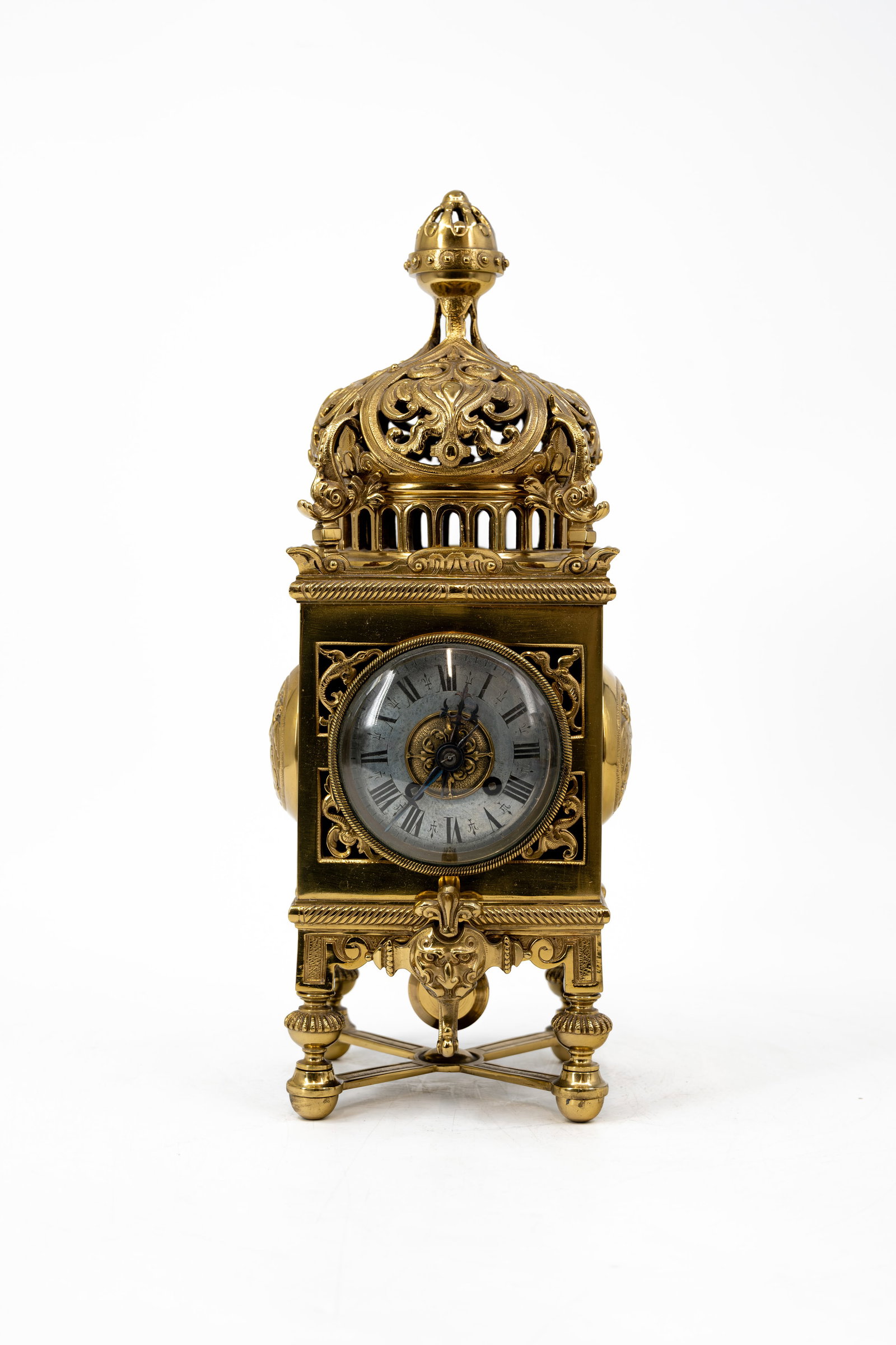 An antique openwork decorated and patinated brass table clock (1 of 11)