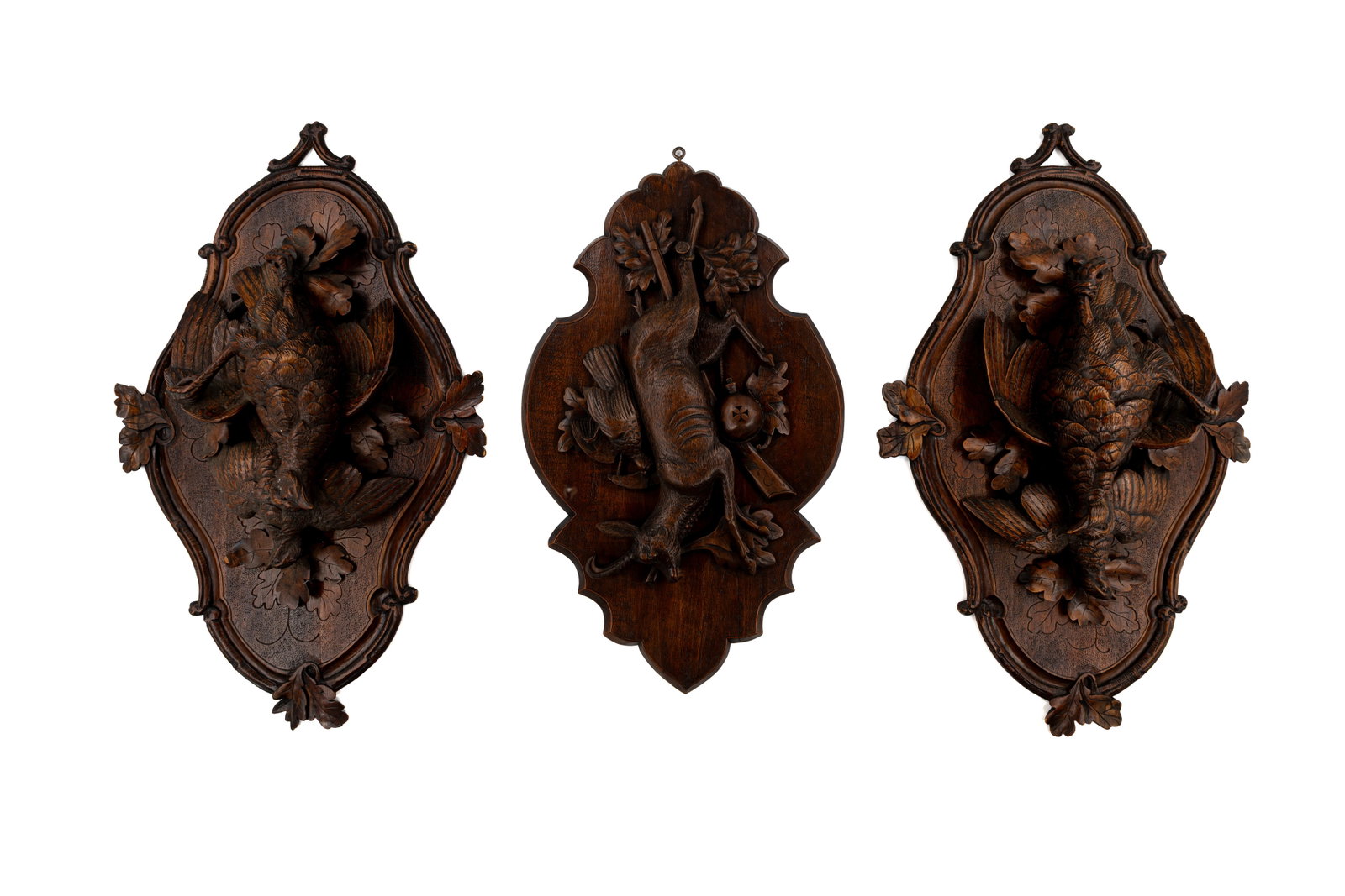 A composed lot of three antique German Black forest carved wooden wall plaques (1 of 7)