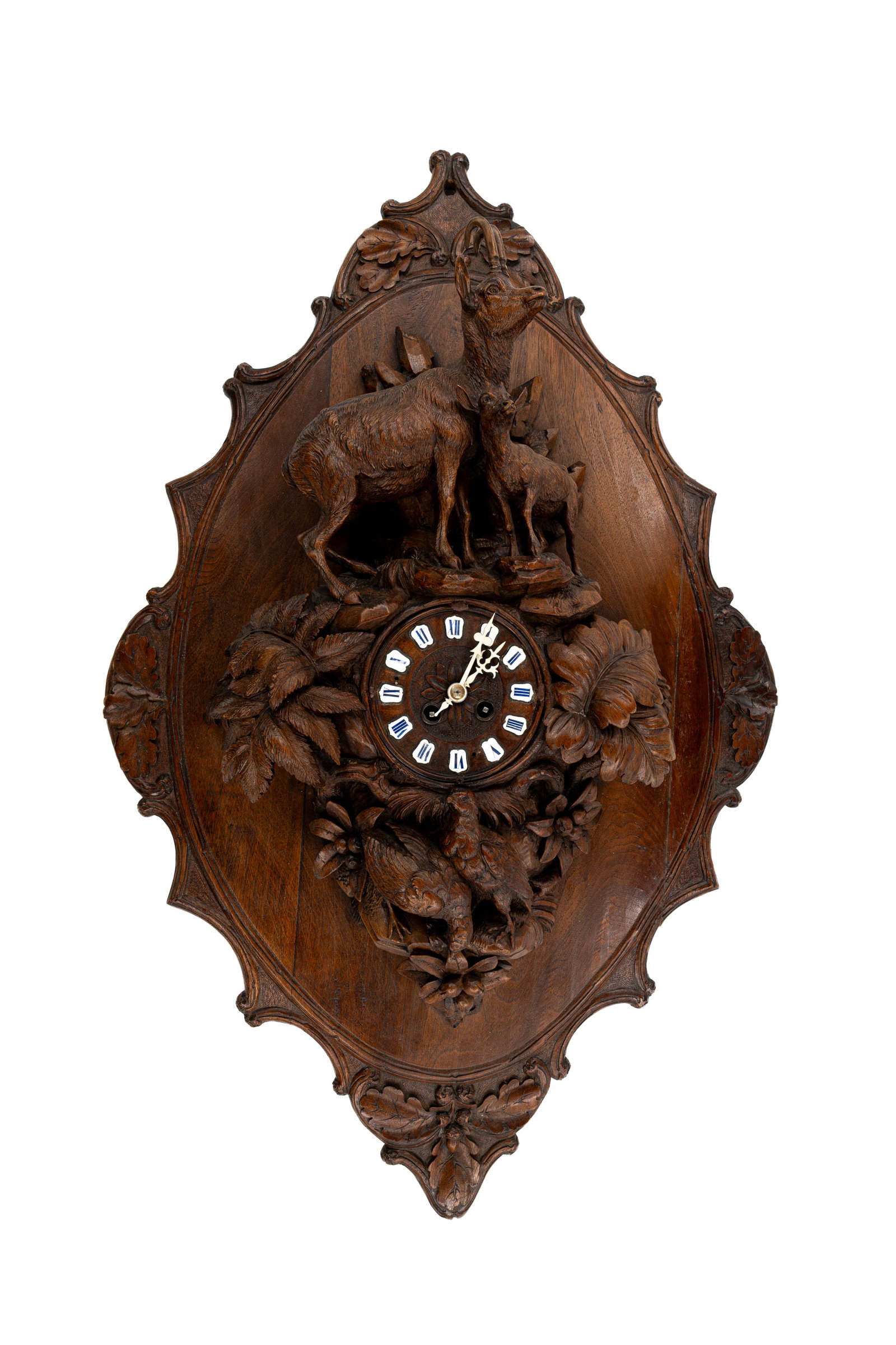 A large and antique German Black Forest carved wooden wall clock: Lot 625. A large and antique German Black Forest carved wooden wall clock, decorated with mountain goats and hunting trophies. 19th/20th century. H: 85 - W: 54 cm