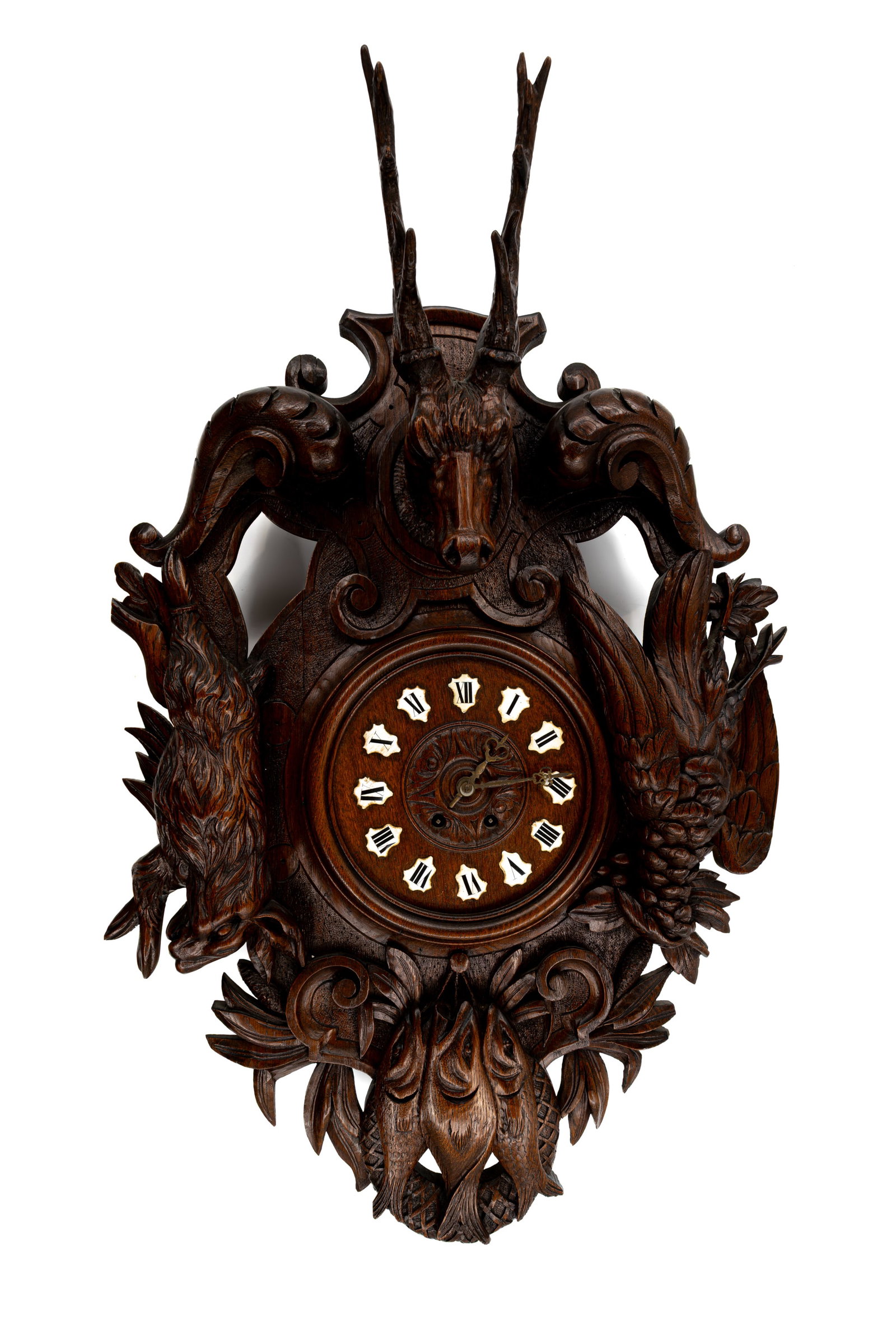 A large and antique German Black Forest carved wooden wall clock, decorated with trophies: Lot 632. A large and antique German Black Forest carved wooden wall clock, decorated with deer and hunting trophies 19th/20th century. H: 80 - W: 60 cm