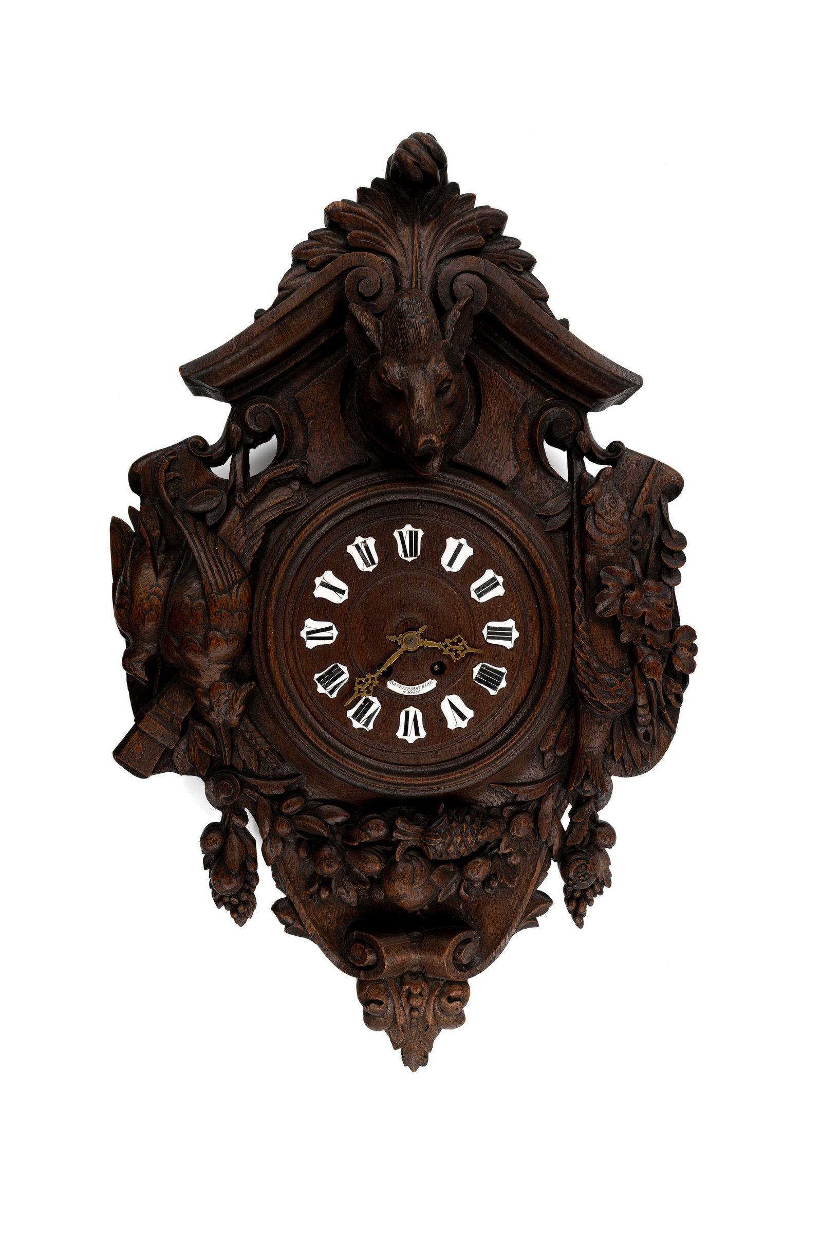 A large and antique German Black Forest carved wooden wall clock: A large and antique German Black Forest carved wooden wall clock, decorated with a boar head and hunting trophies. 19th/20th century. H: 85 - W: 55 cm