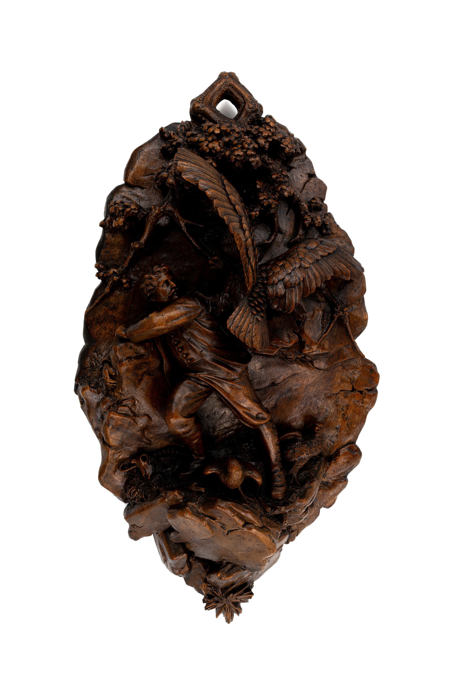 An antique German Black Forest carved wooden wall ornament: An antique German Black Forest carved wooden wall ornament depicting a dramatic hunting scene with a hunter and an eagle. 19th/20th century. H: 76 - W: 42 cm