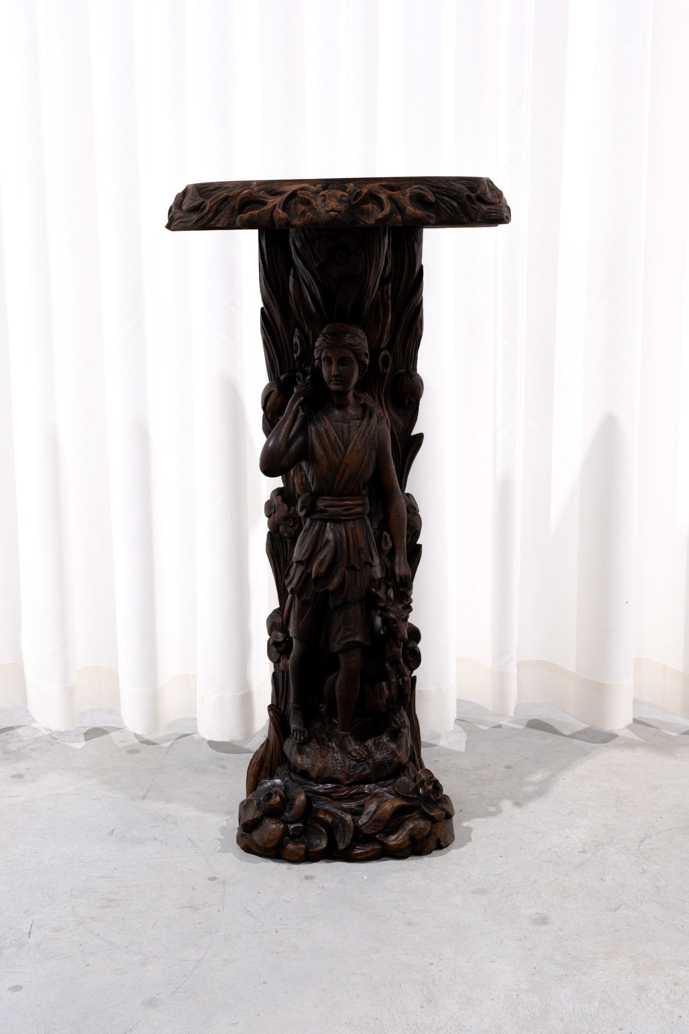 A large and antique carved wood figural pedestal sculpture representing of Diana: A large and antique carved wood figural pedestal sculpture representing of Diana, goddess of the hunt. 19th century. H: 89 - W: 43 cm