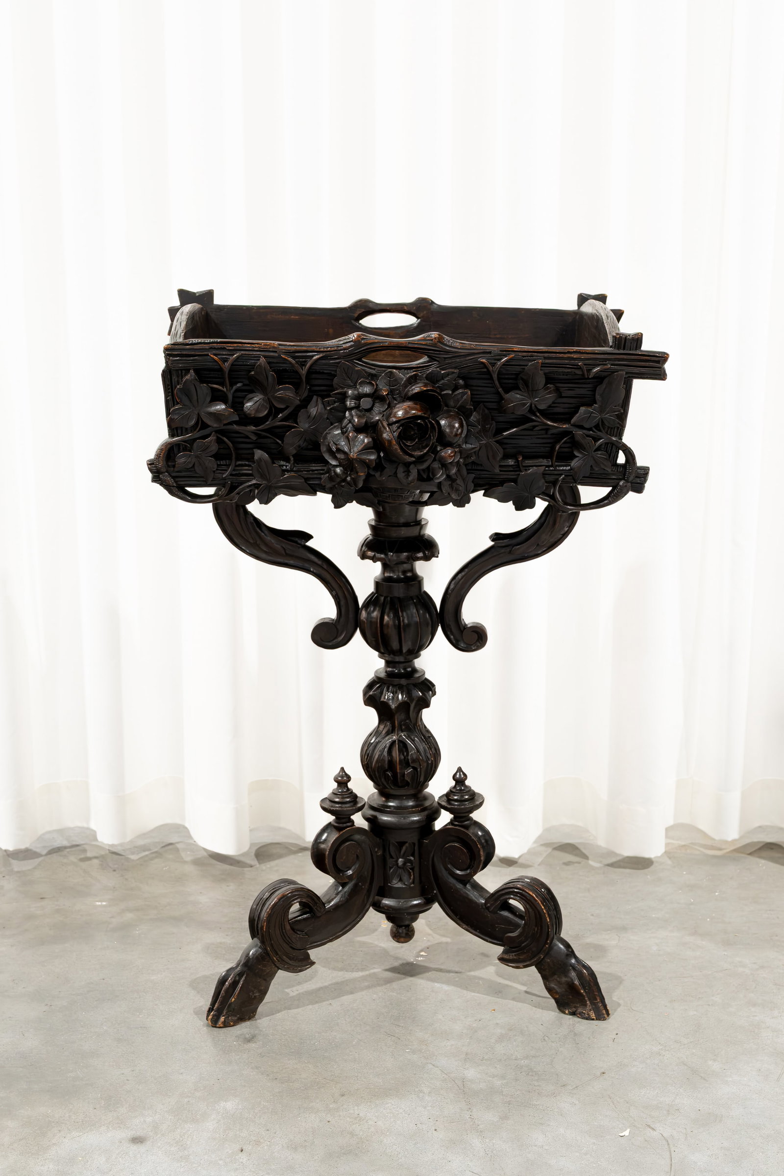 An antique carved wooden planter, richly decorated and raised on a tripod base (1 of 9)
