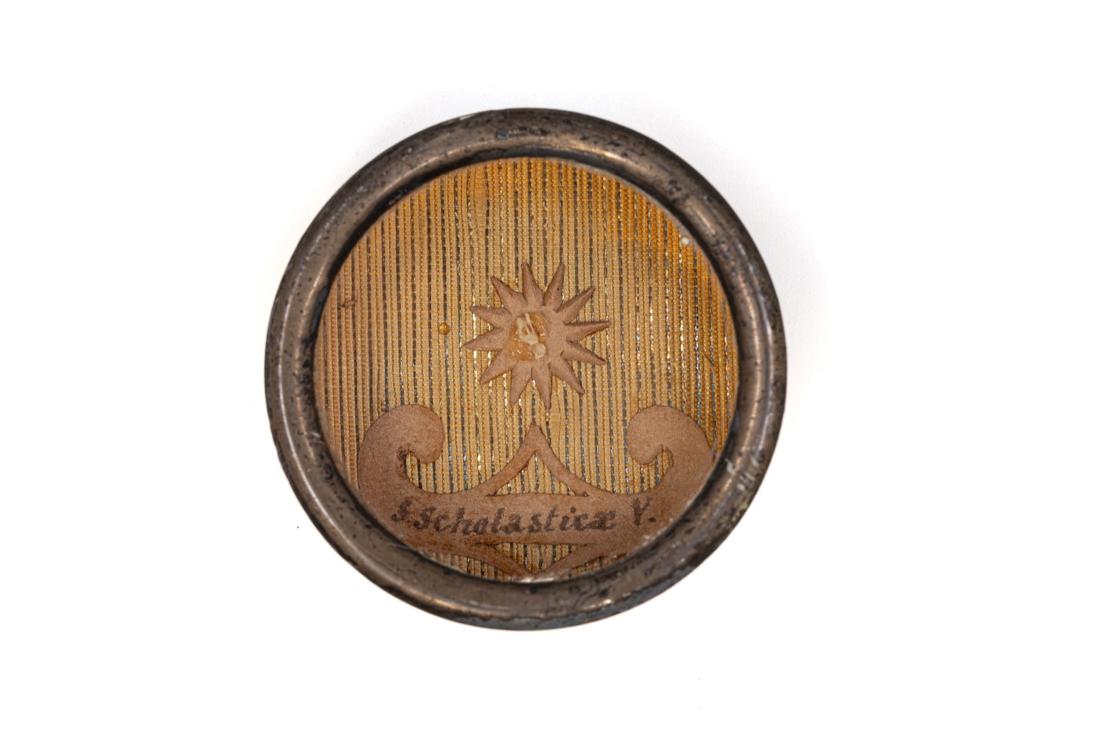 A sealed theca containing a relic of Saint Scholastica, with a Certificate of Authenticity: A sealed theca containing a relic of Saint Scholastica, Virgin, with an Engelbertus Certificate of Authenticity. "S. Scholasticae V." 1847 W: 3,6 cm The theca and any accompanying documentation are av