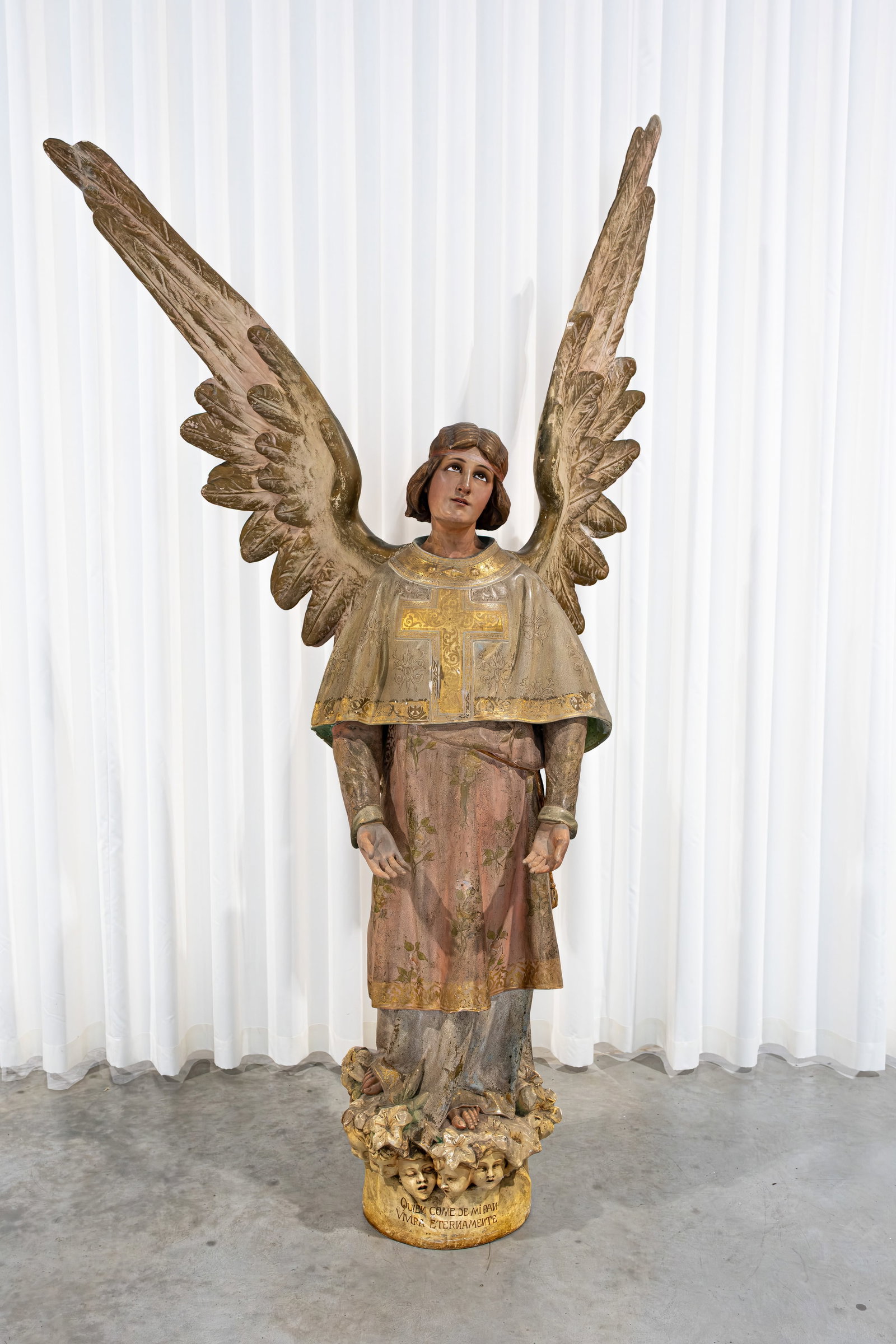 A life size religious and antique Neo-gothic patinated plaster and wood figure of archangel: A life size and imposing religious and antique Neo-gothic patinated plaster and wood figure of archangel with glass eyes and putti heads on the base. The wings are dismountable. Late 19th century. H: 