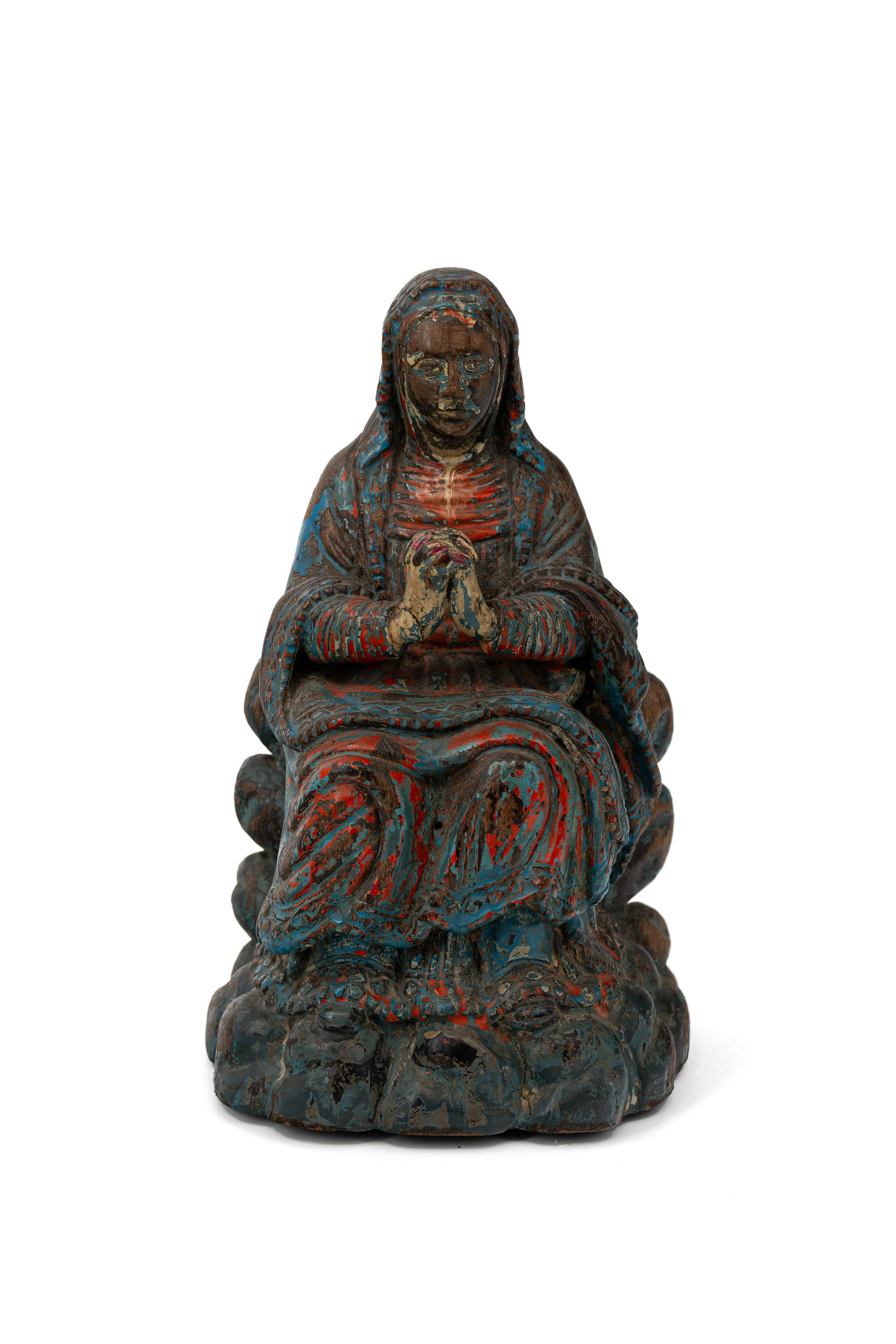 An antique religious polychrome multi-patinated figural carved wooden sculpture: An antique religious polychrome multi-patinated figural carved wooden sculpture of praying seated Madonna. 18th century. H: 27 cm