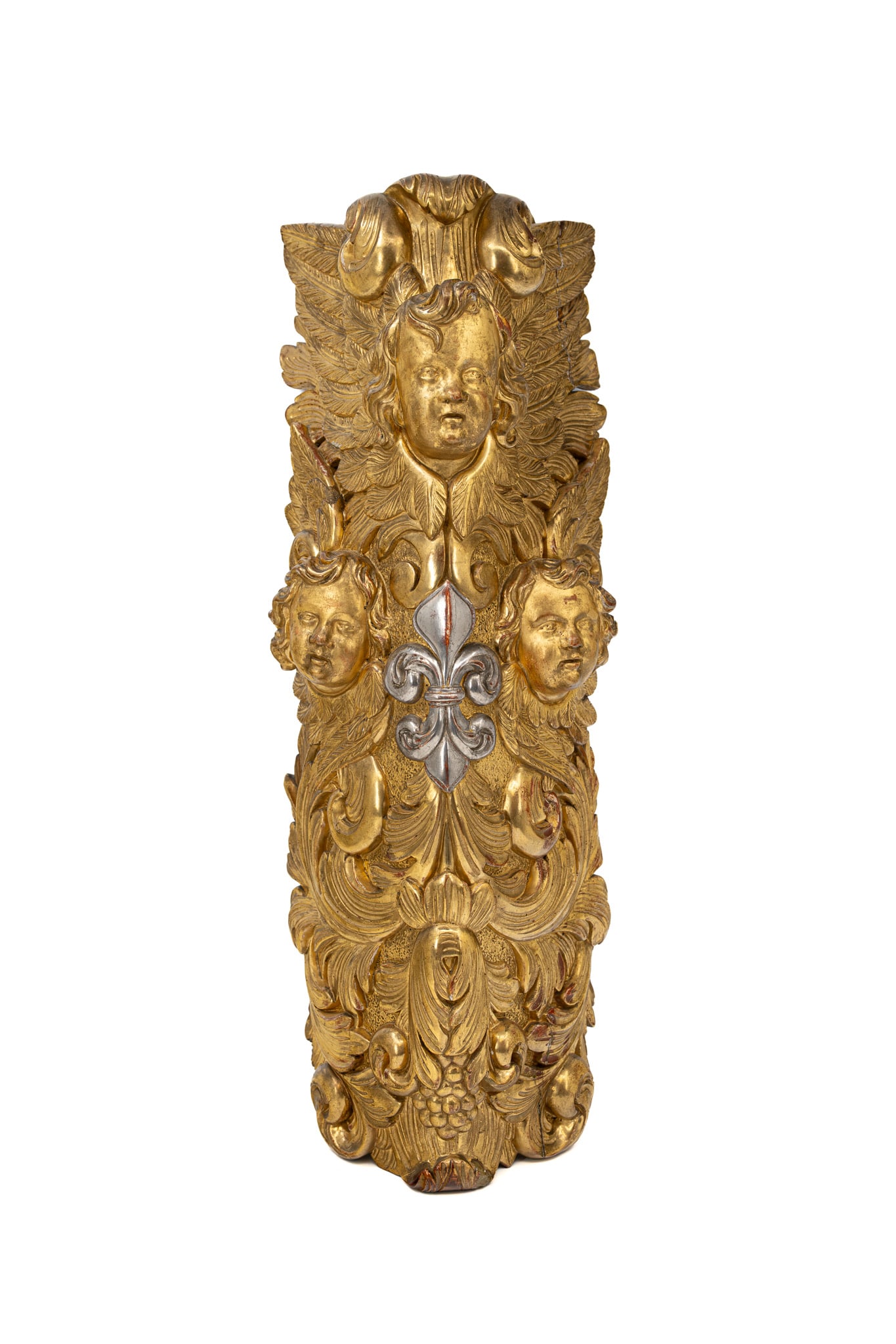A large and antique polychrome gilt wood carved wall ornament: A large and antique polychrome gilt wood carved wall ornament flanked by cherubs and Fleur de lis motifs. 18th century. H: 77 cm