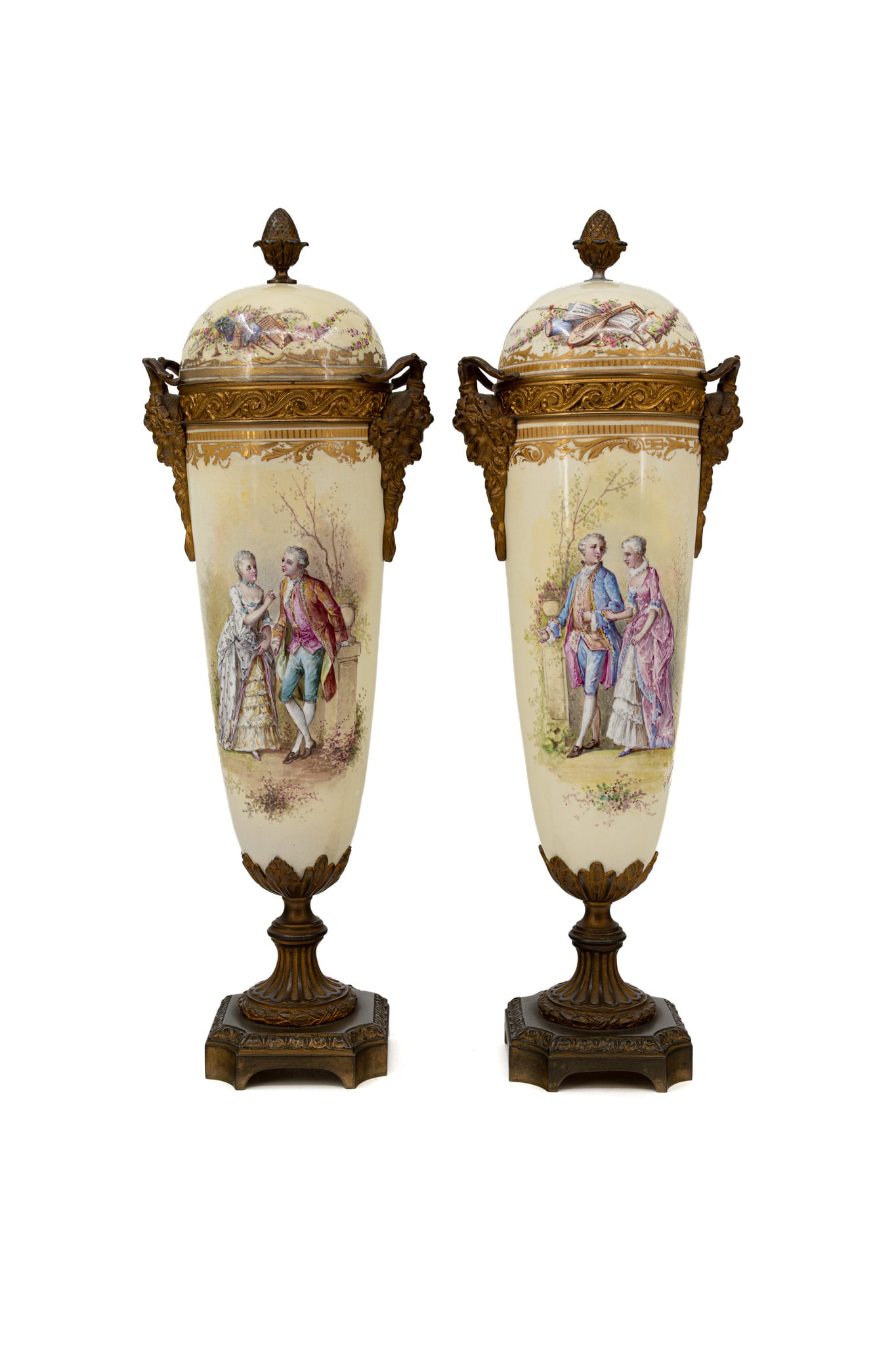 A pair of antique French Sevres style decorated porcelain covered urn vases with bronze mountings: A pair of antique French Sevres style decorated porcelain covered urn vases with bronze mountings and Bacchus shaped heads. The front features a gallant scene and the backside a floral decor. Late 19t