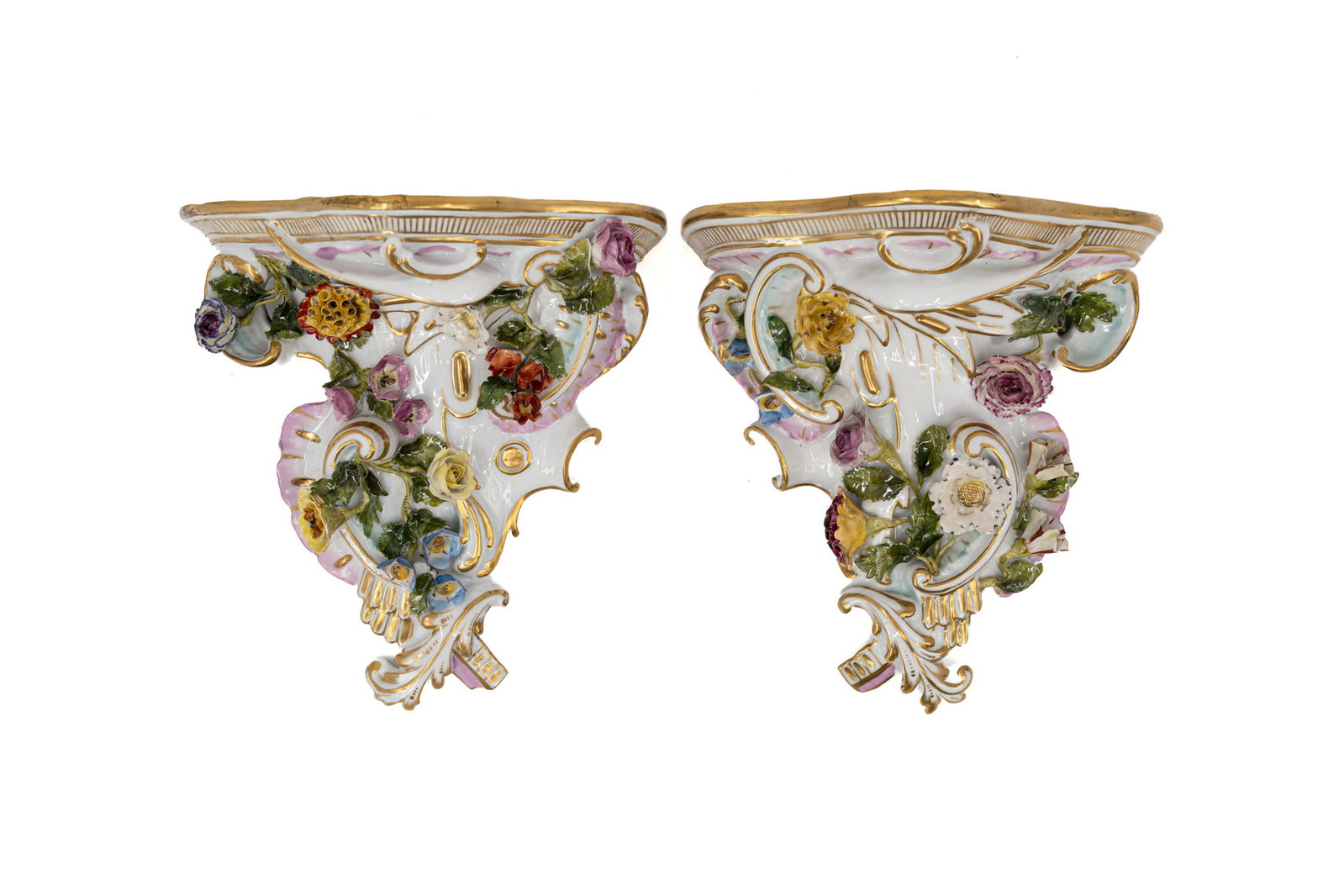 A pair of antique richly decorated porcelain wall consoles in Rococo saxony style: A pair of antique richly decorated porcelain wall consoles in Rococo saxony style, decorated with polychrome flowers and gilt details. Blue crossed swords marks. Late 19th century. H: 21 - W: 20 cm