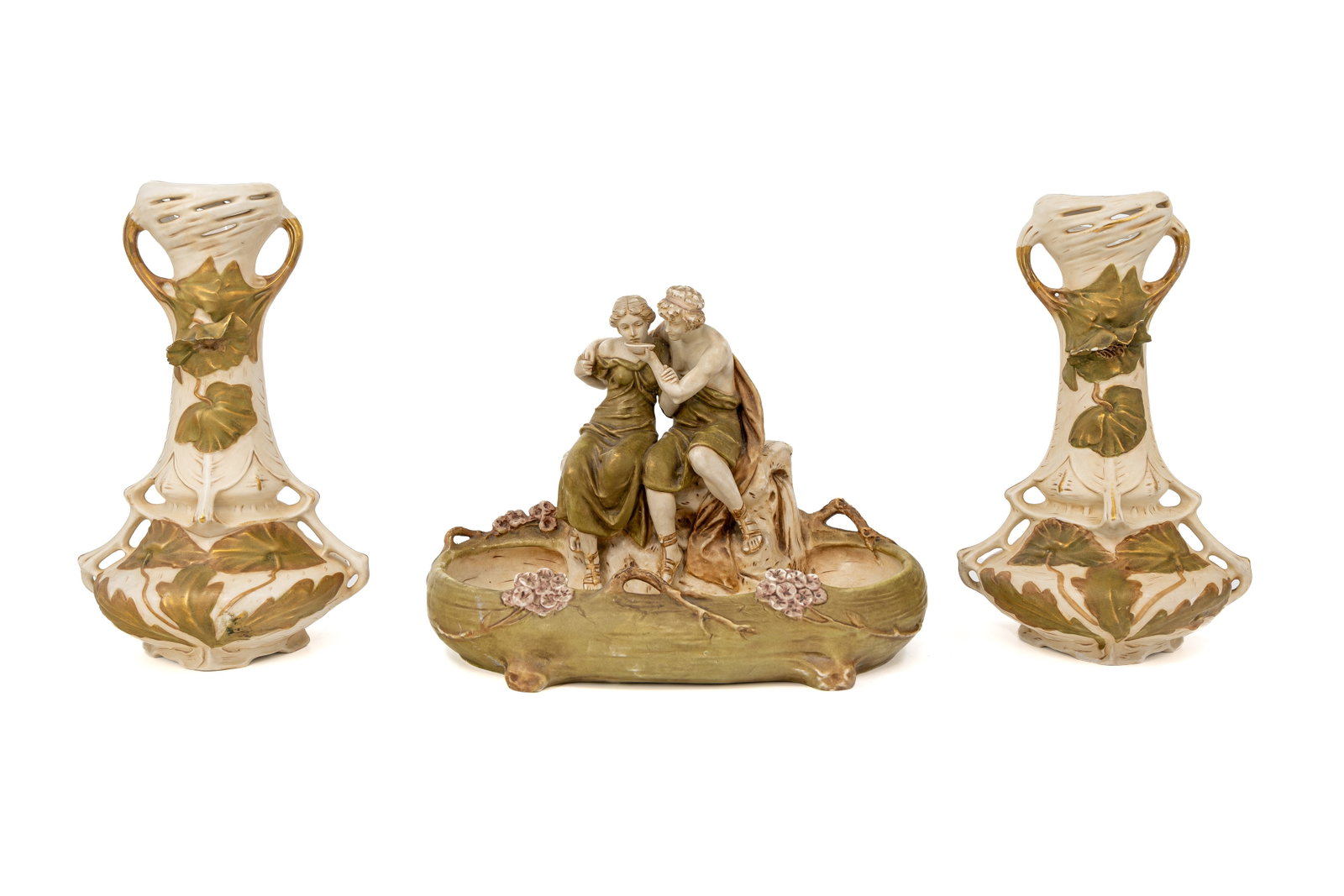 An Art Nouveau Bohemian Royal Dux figural porcelain centerpiece and two matching vases: An Art Nouveau Bohemian Royal Dux figural porcelain centerpiece assembled with two matching vases. Marked and first half of the 20th Century. H: 34 - 26,5 - 33 cm.