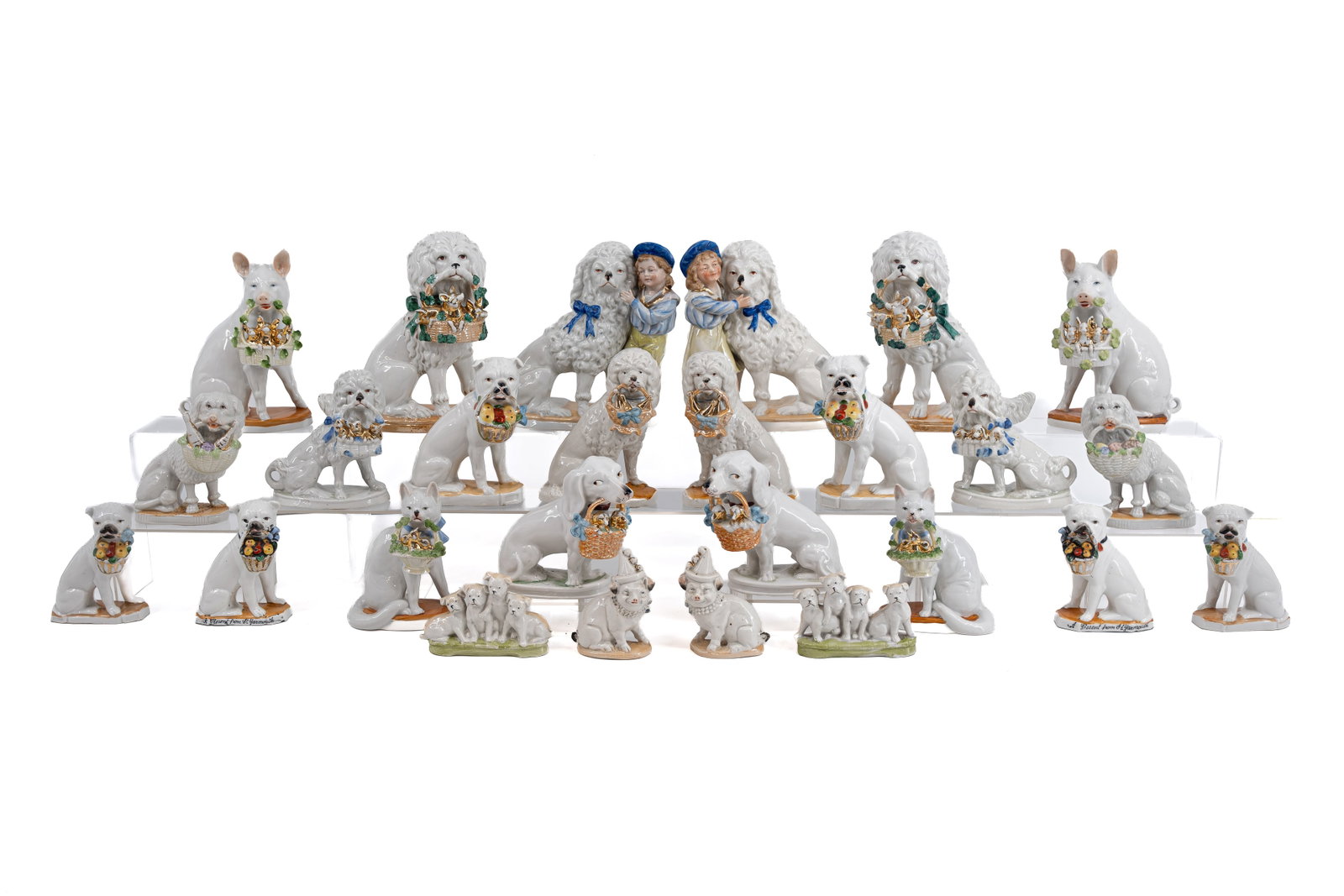 A large collection of 13 pairs of antique decorated biscuit figurines of various animals: A large collection of 13 pairs of antique decorated biscuit figurines of various animals holding baskets. Numbered, circa 1900. Condition: some have a small hairline, a condition report is available u