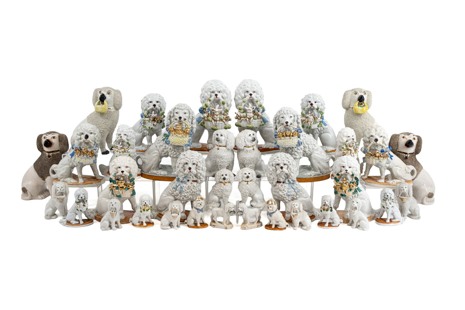 A large collection of 18 pairs of antique decorated biscuit figurines of dogs holding baskets (1 of 10)