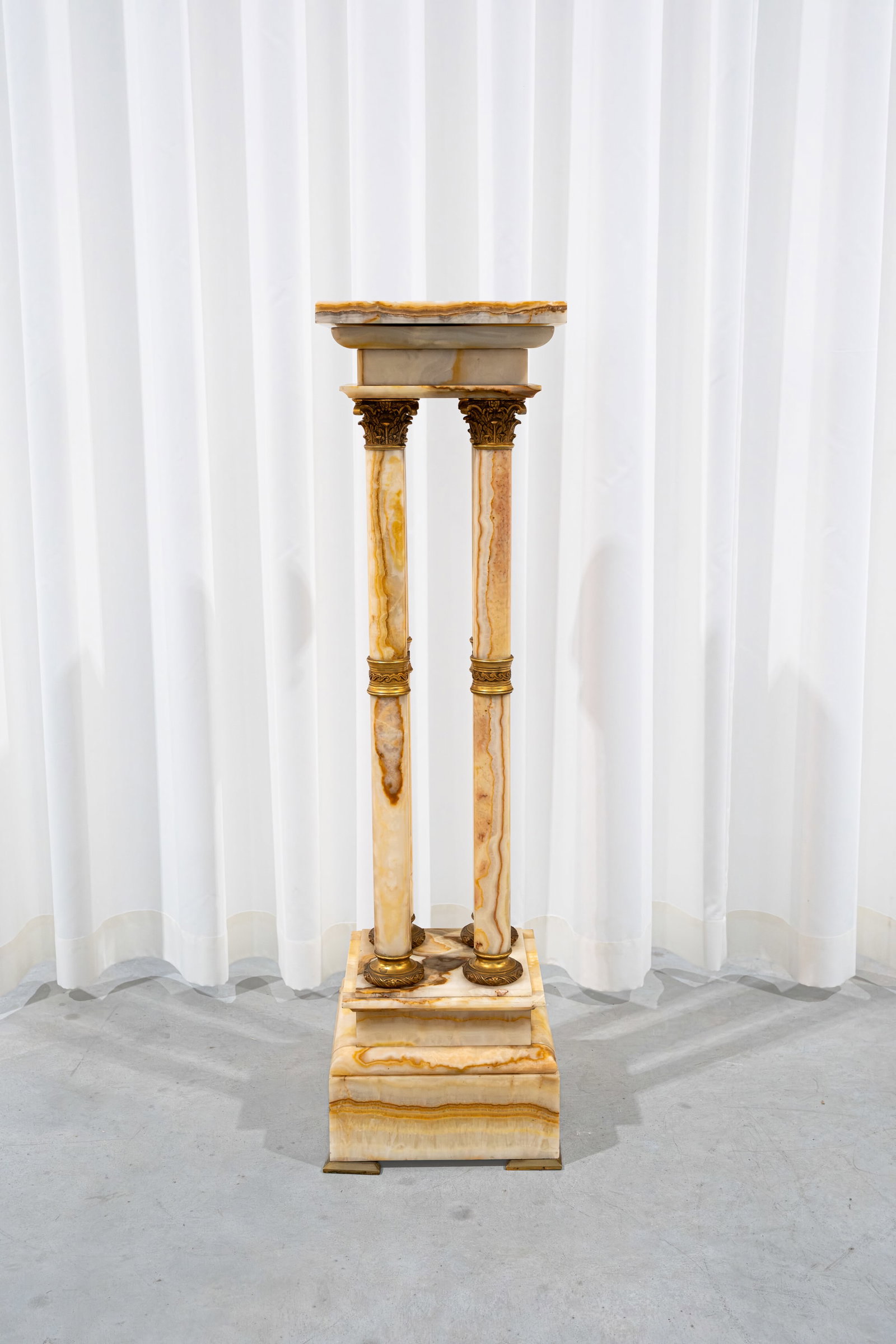 An antique neo-classical gilt bronze mounted onyx marble pedestal with four columns and a rotating (1 of 3)