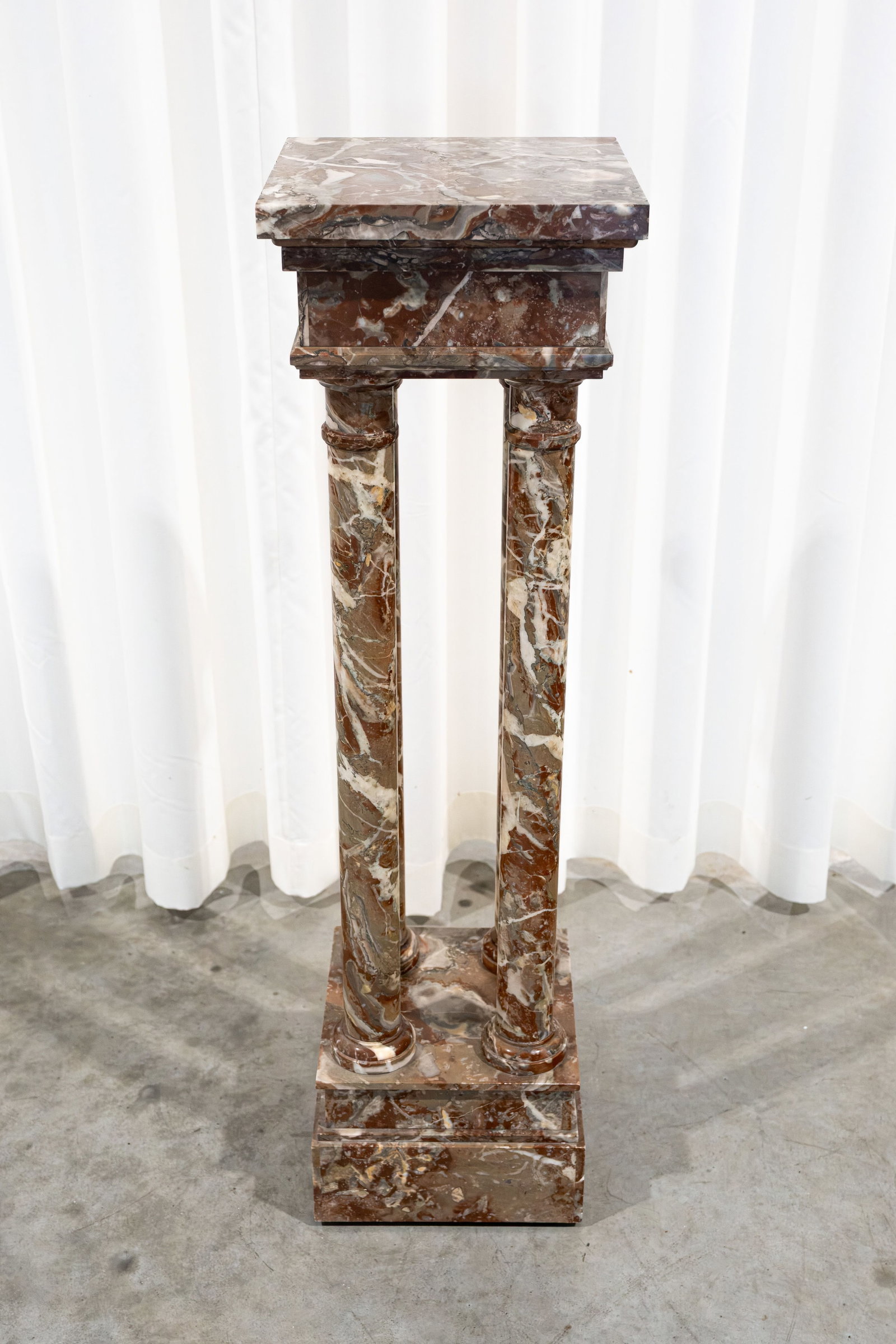 An antique square-shaped red marble pedestal raised on four columns (1 of 5)