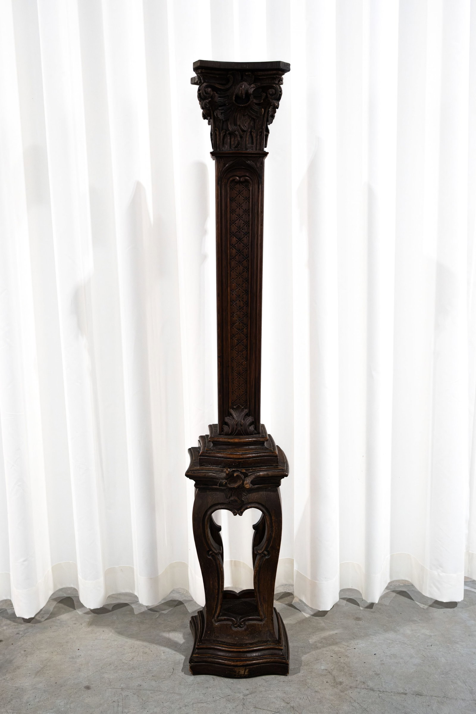 An antique Baroque-style carved wooden pedestal with an openwork base (1 of 4)