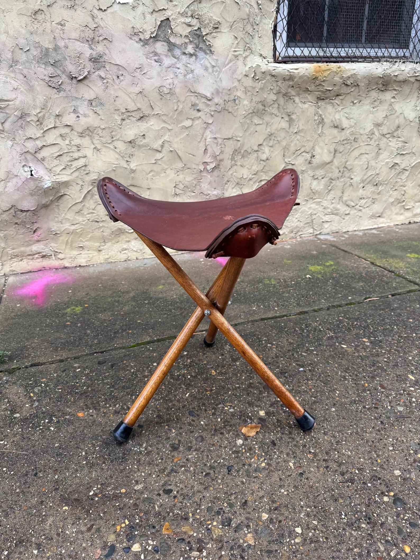 Danish Modern Tripod Stool: Minimalist Danish modern tripod stool featuring solid walnut base and original leather seat. Compact sculptural form ideal as seating or accent table.