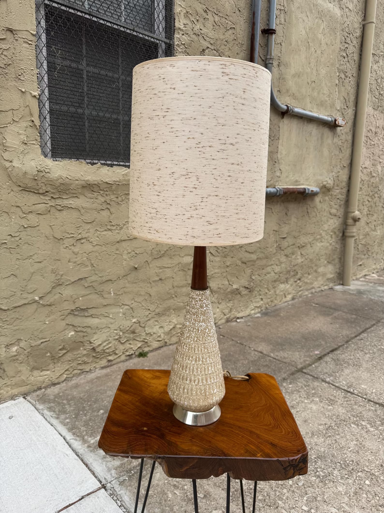 Mid Century Ceramic Table Lamp with Walnut Accents, 1970's Modern: Refined mid-century modern table lamp featuring a smooth ceramic body accented with warm walnut detailing. The contrast of organic wood and glazed ceramic creates a clean, sculptural silhouette typica