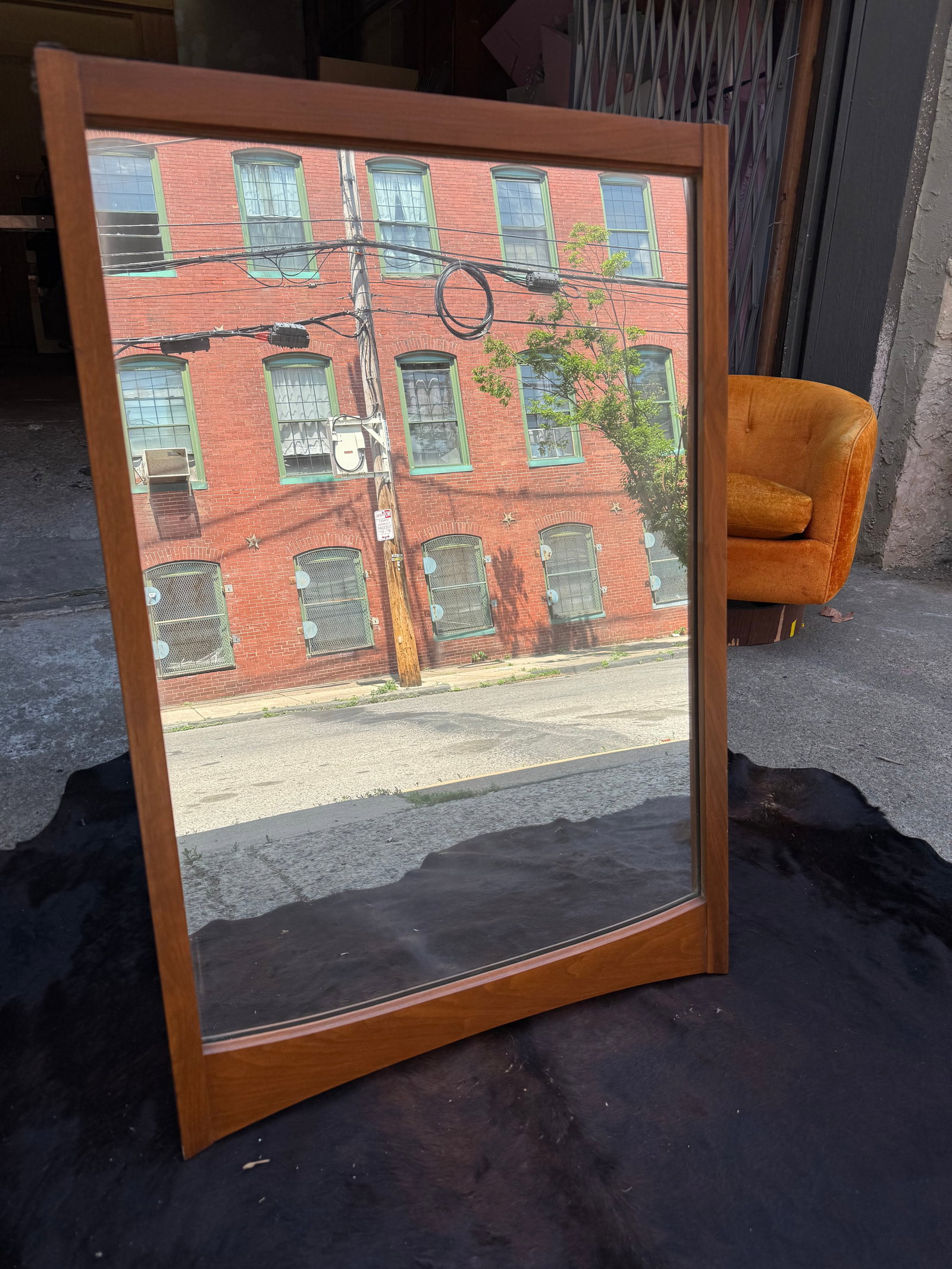 Mid-Century Modern Kent Coffey Walnut Wall Mirror: Elegant mid-century modern wall mirror attributed to Kent Coffey, featuring a richly grained walnut frame and signature sculptural detailing. The minimalist rectangular form is elevated by a distincti