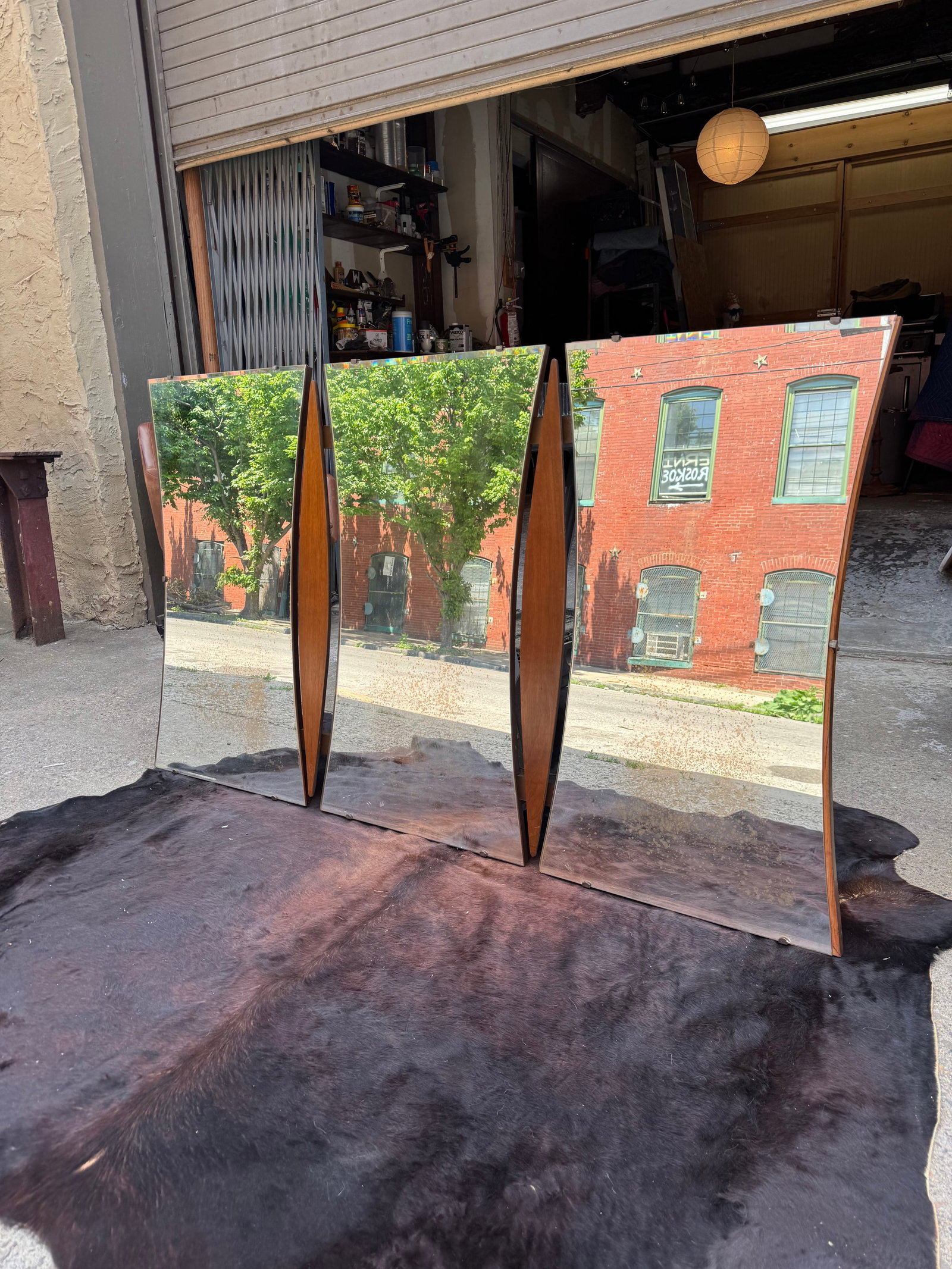 Mid-Century Modern Triple “Boat Shape?? Wall Mirror: Mid-century modern triptych wall mirror featuring a dramatic boat-shaped silhouette with three flared mirrored panels divided by sculptural curved walnut inserts. The back is finished in richly figure