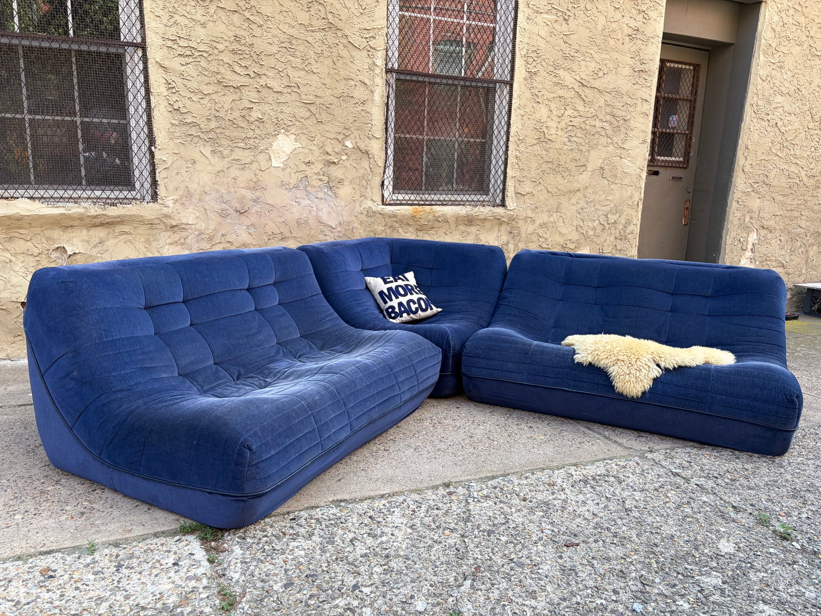Roche Bobois Postmodern Modular Sectional Sofa: Rare three-piece modular sectional sofa by Roche Bobois, France, dated 1979, embodying the bold forms and relaxed comfort of late-1970s Postmodern design. Comprised of two curved sofa modules and a de