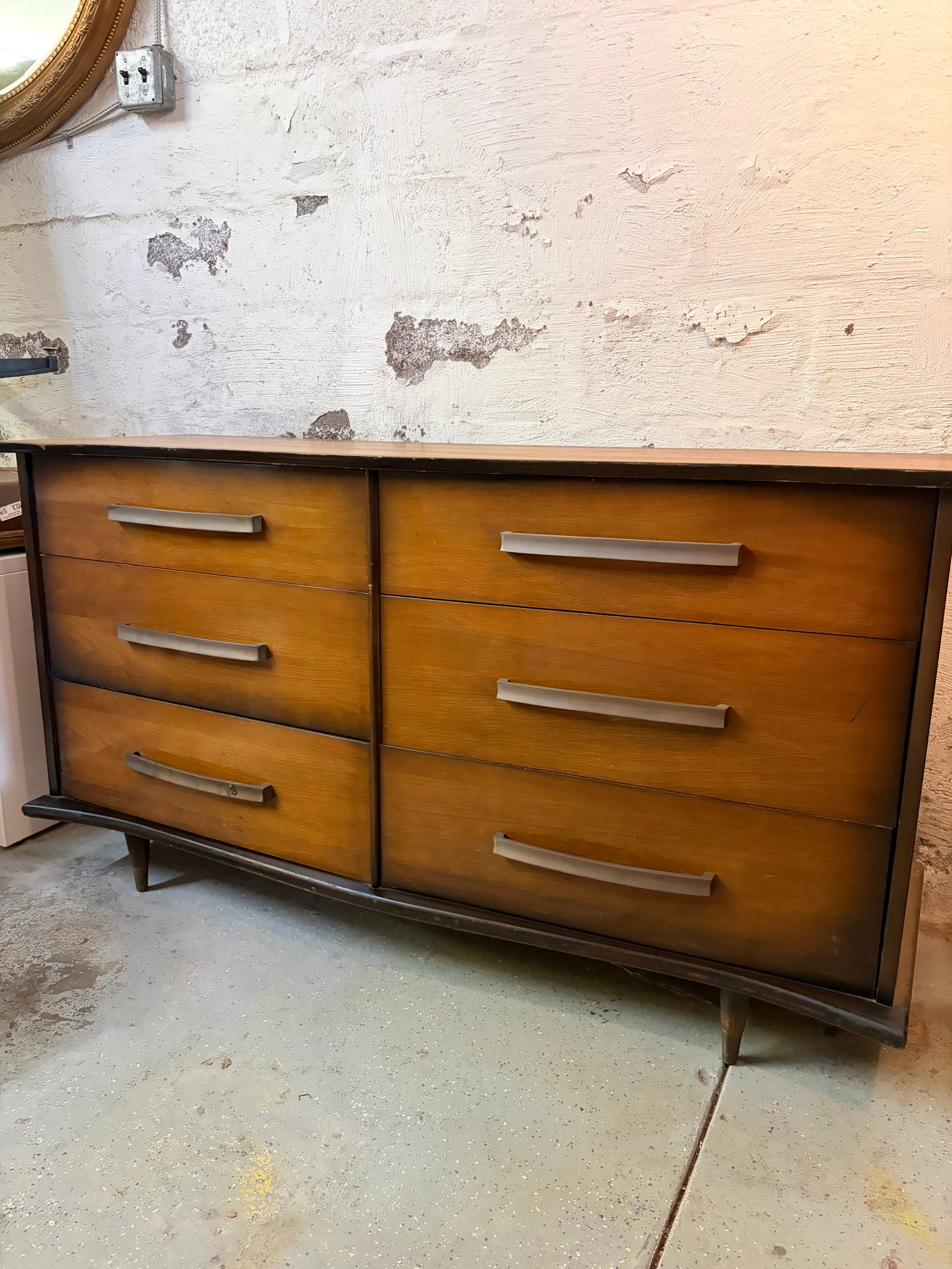 Mid-Century Modern 6-Drawer Dresser: Classic Mid-Century Modern dresser featuring a clean, streamlined silhouette and beautifully grained wood throughout. The six spacious drawers are fitted with iconic brushed metal bow-style pulls, off