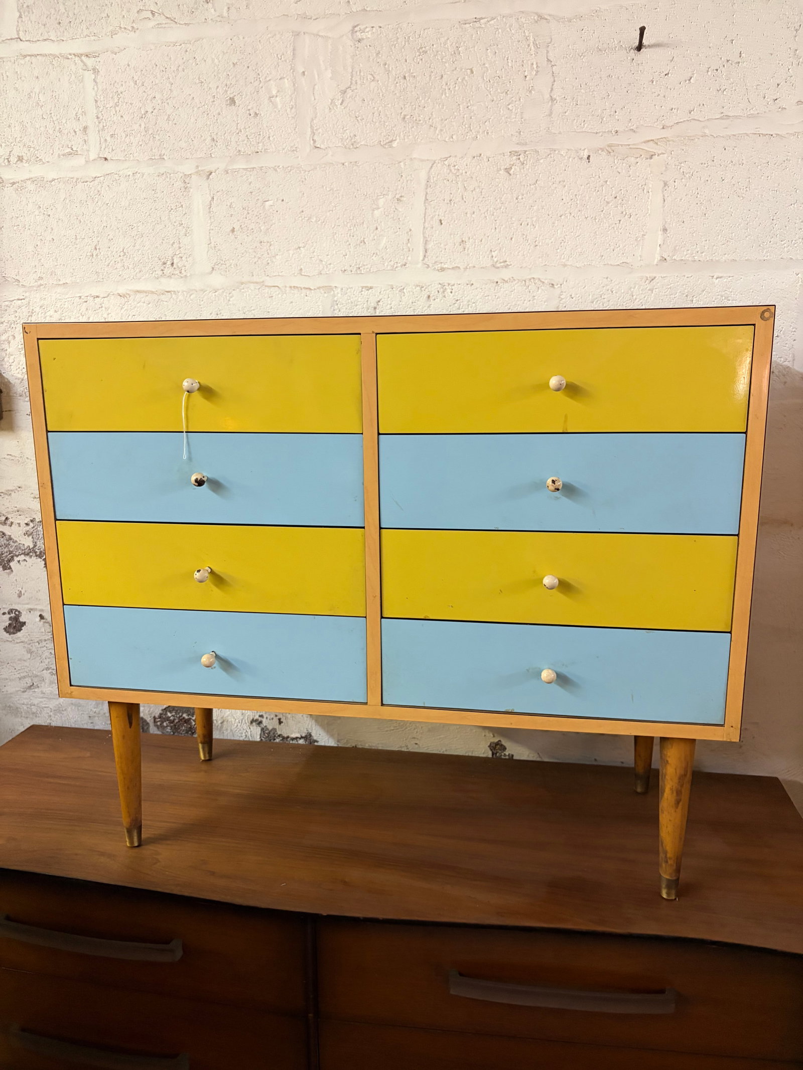 Mid-Century Modern Blue and Yellow 8-Drawer Chest: Exceptional Mid-Century Modern chest of drawers showcasing a distinctive blend of warm ash veneer and playful post-war European design. The case features eight drawers arranged in a two-column layout 