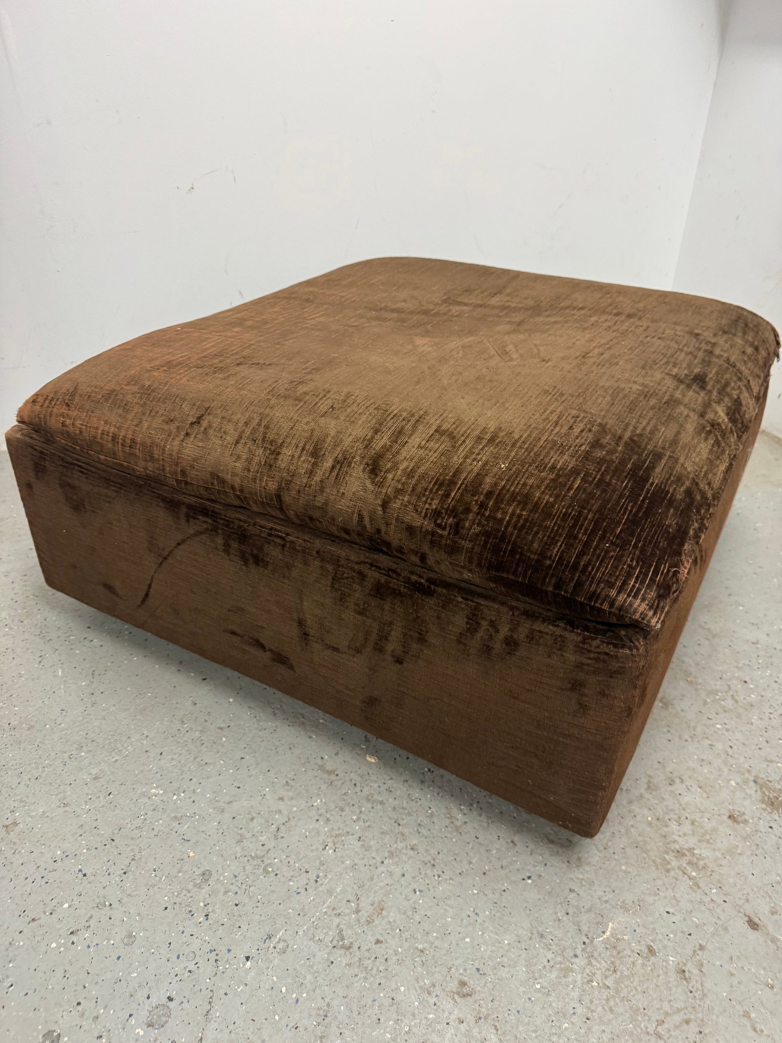 Vintage Mid-Century Modern Minimalist Block Ottoman: Mid-century modern block-style ottoman, circa 1970s, featuring a low-profile monolithic form and clean geometric lines. Upholstered in original textured brown plush fabric with a deep chocolate tone a
