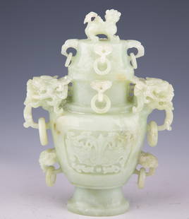 Chinese Carved Celadon Jade Covered Urn with Fu Lion Finial: Chinese Carved Celadon Jade Covered Urn with Fu Lion Finial" Introduction:
Transport yourself to the refined elegance of ancient China with this exceptional carved celadon jade covered