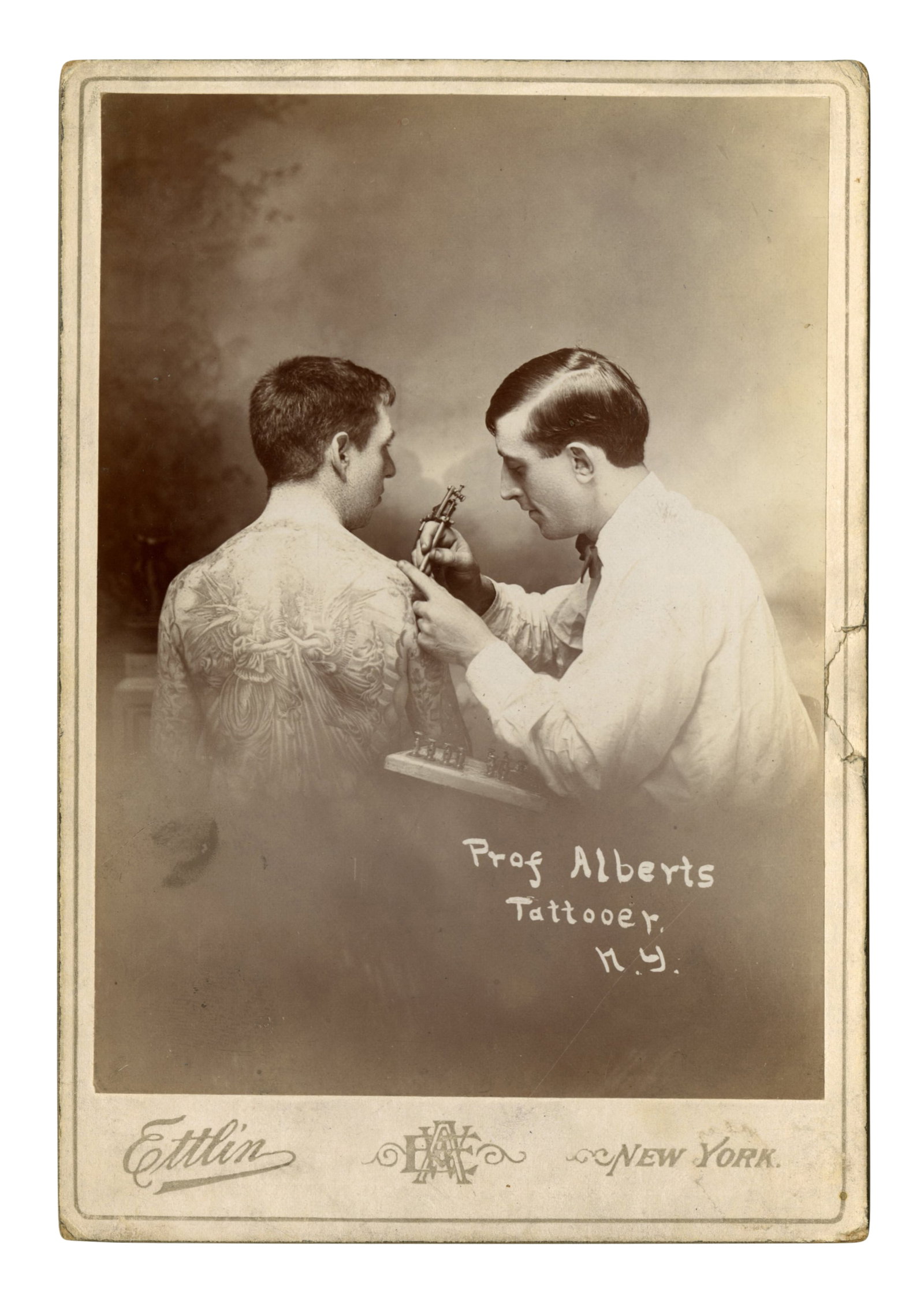 Cabinet Card of Tattoo Artist Lew "The Jew" Alberts [Circus - Bowery - Jewish] (New York, ca. 1905): Cabinet Card of Tattoo Artist Lew "The Jew" Alberts [Circus - Bowery - Jewish] (New York, ca. 1905) Depicting Lew Alberts (1880-1954), real name Albert Kurzman, tattooing Philadelphia's William A. Par