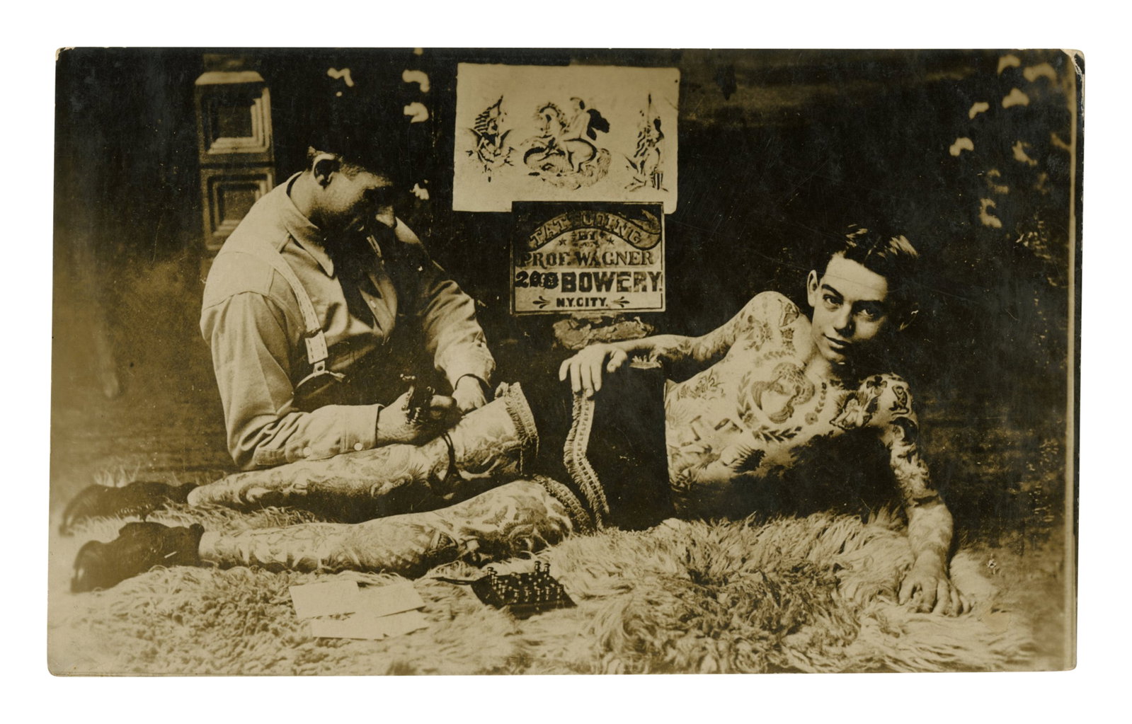 Photograph of Charlie Wagner Tattooing a Boy [Bowery - Tattoo], (New York, ca. 1920) 3 1/2 x 5 3/4 (1 of 2)