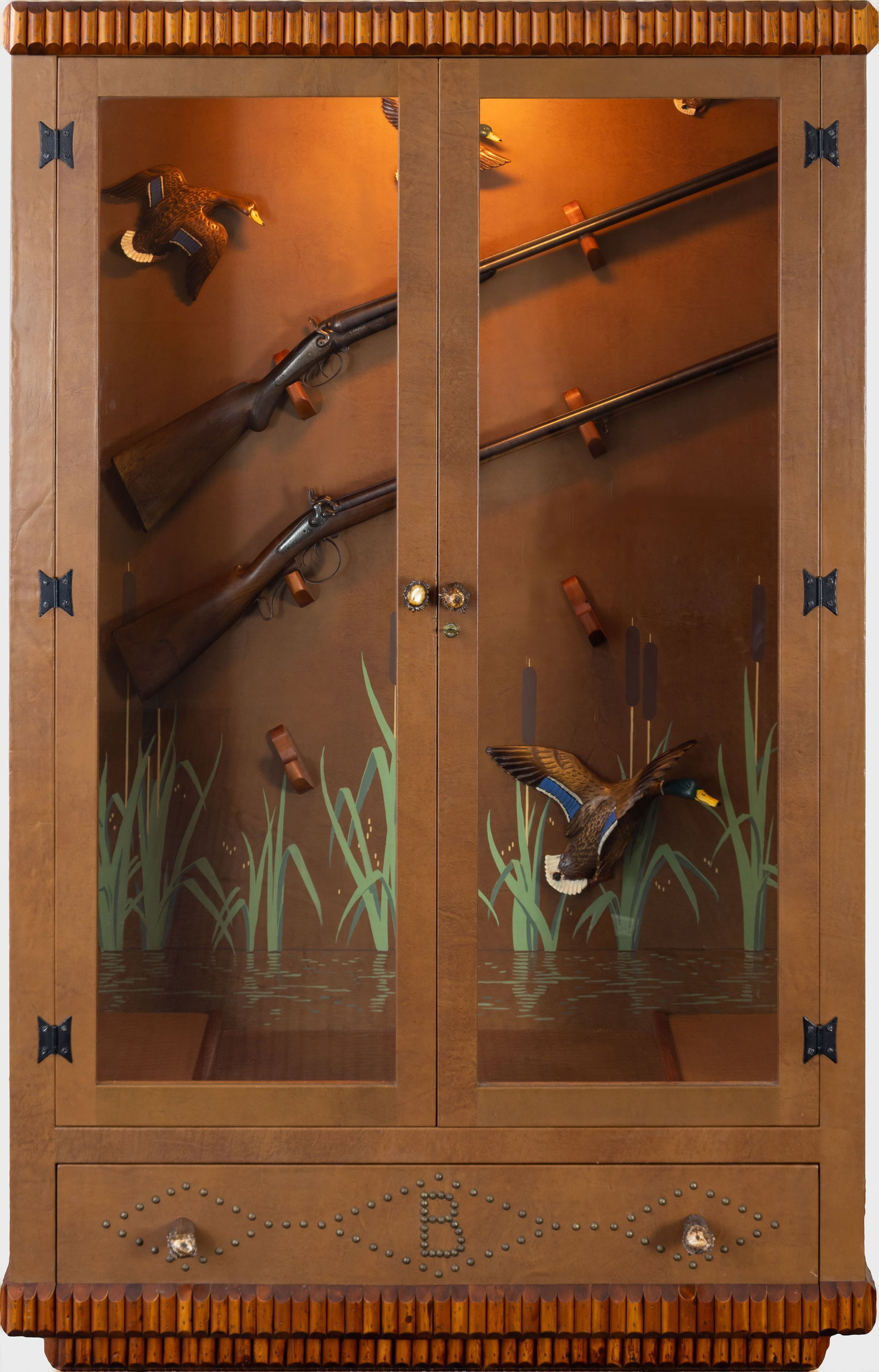 Thomas Molesworth, Gun Cabinet, c. 1950s: Thomas Molesworth 1890-1877 Leather-Wrapped Gun Cabinet with Applied Pole Trim, Antler Pulls, Painted Leather Interior, and Four Wood-carved Ducks, c. 1950s inland fir, leather, antler, brass tacks