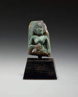 AN EGYPTIAN FAIENCE AMULET OF A WOMAN WITH SHORT-HAIRED WIG: "