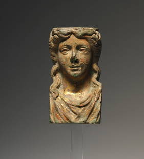 A GREEK HELLENISTIC GILDET BRONZE FITTING IN THE SHAPE OF A BUST: "