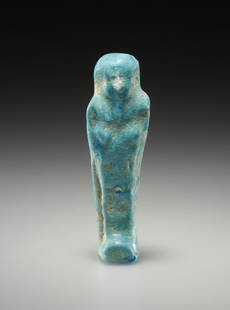 AN EGYPTIAN FAIENCE USHEBTI: "