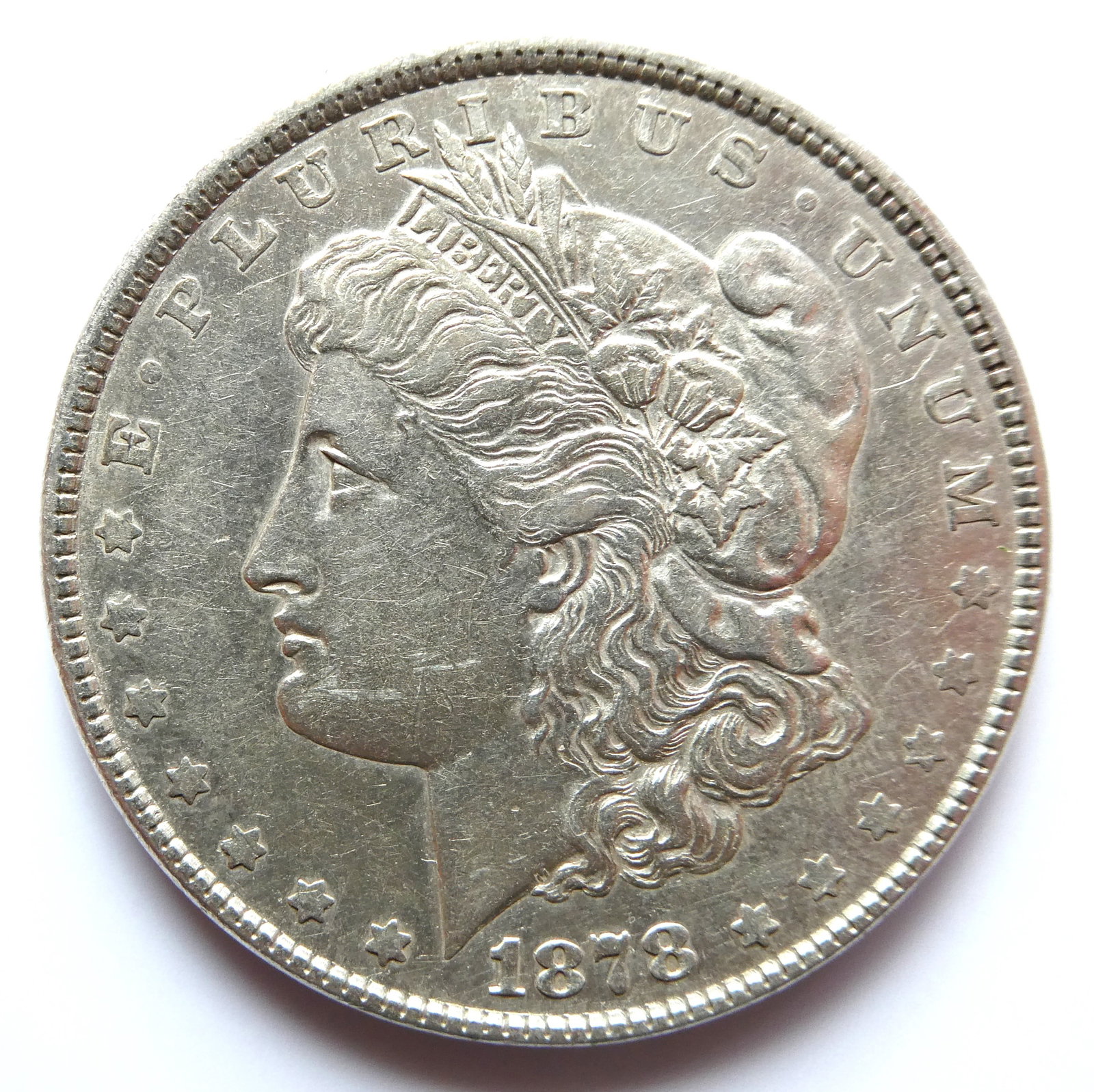 1878 Morgan Dollar: Both the original Morgan and Peace Dollars were 90 percent silver and 10 percent copper. Coin weighs in at 26.73 grams (. 859 troy ounces) and contains 0.77344 troy ounces of silver.